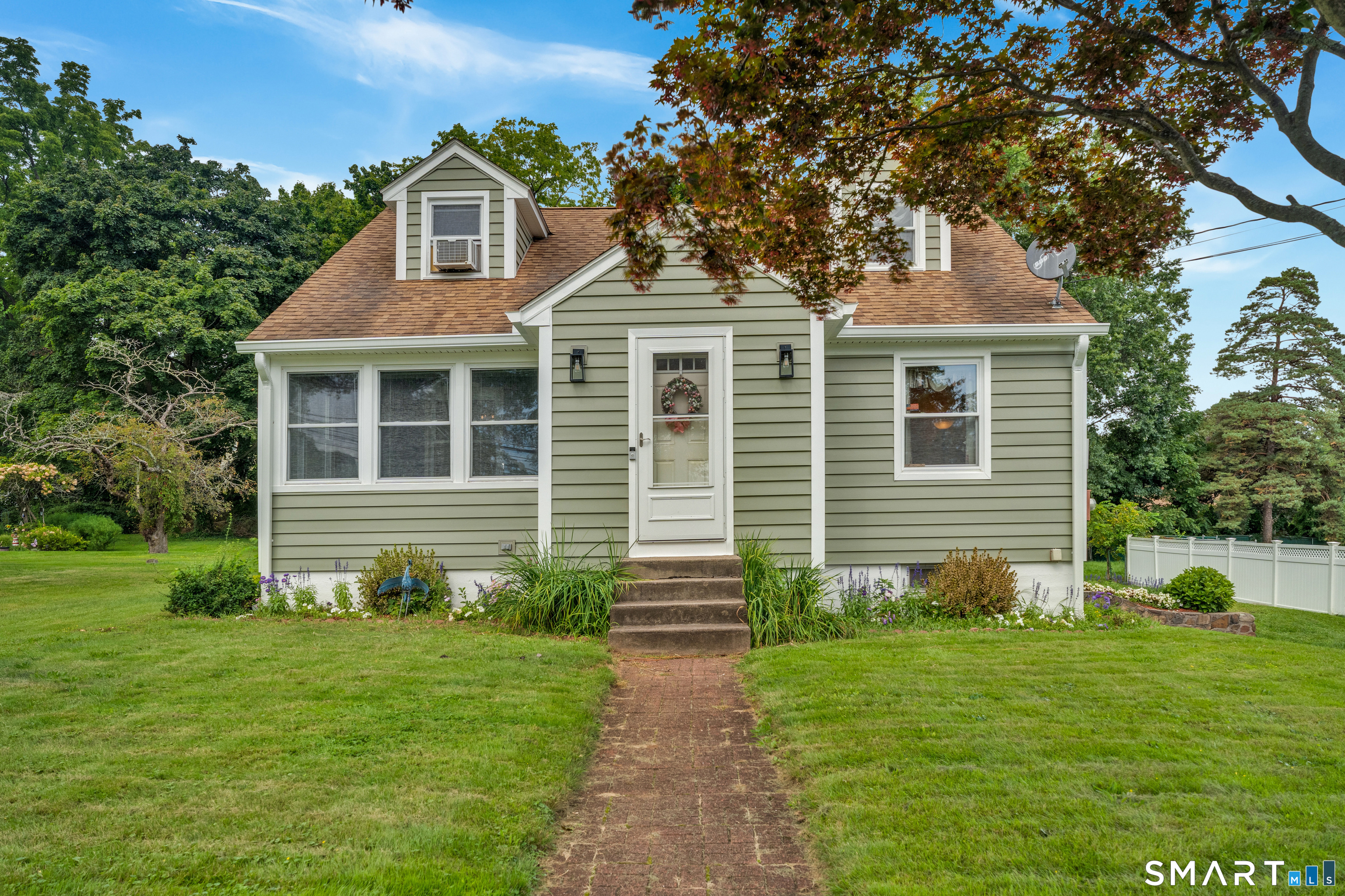 Welcome to 167 Johnson Ave, a charming Cape offering a wonderful combination of classic character, comfortable living space and a beautiful leveled yard. Step inside to a bright interior with hardwood floors and plenty of natural light. The spacious living room provides a place to gather and relax, while the 3-season room offers a comfortable spot to enjoy your morning coffee.  The eat-in kitchen features new flooring and granite countertops. The main level includes two bedrooms and a full bath, while the second floor offers the primary bedroom along with additional space that could be used as a fourth bedroom, office, or sitting area. The basement provides plenty of storage and potential to finish for additional living space, with a dedicated laundry area.  Additional updates include new siding with a one-time transferable warranty, a septic system replaced in 2012, and a driveway completed in 2018. With its flexible floor plan, updated kitchen, and potential for additional living space, 167 Johnson Ave is ready for its next owner.