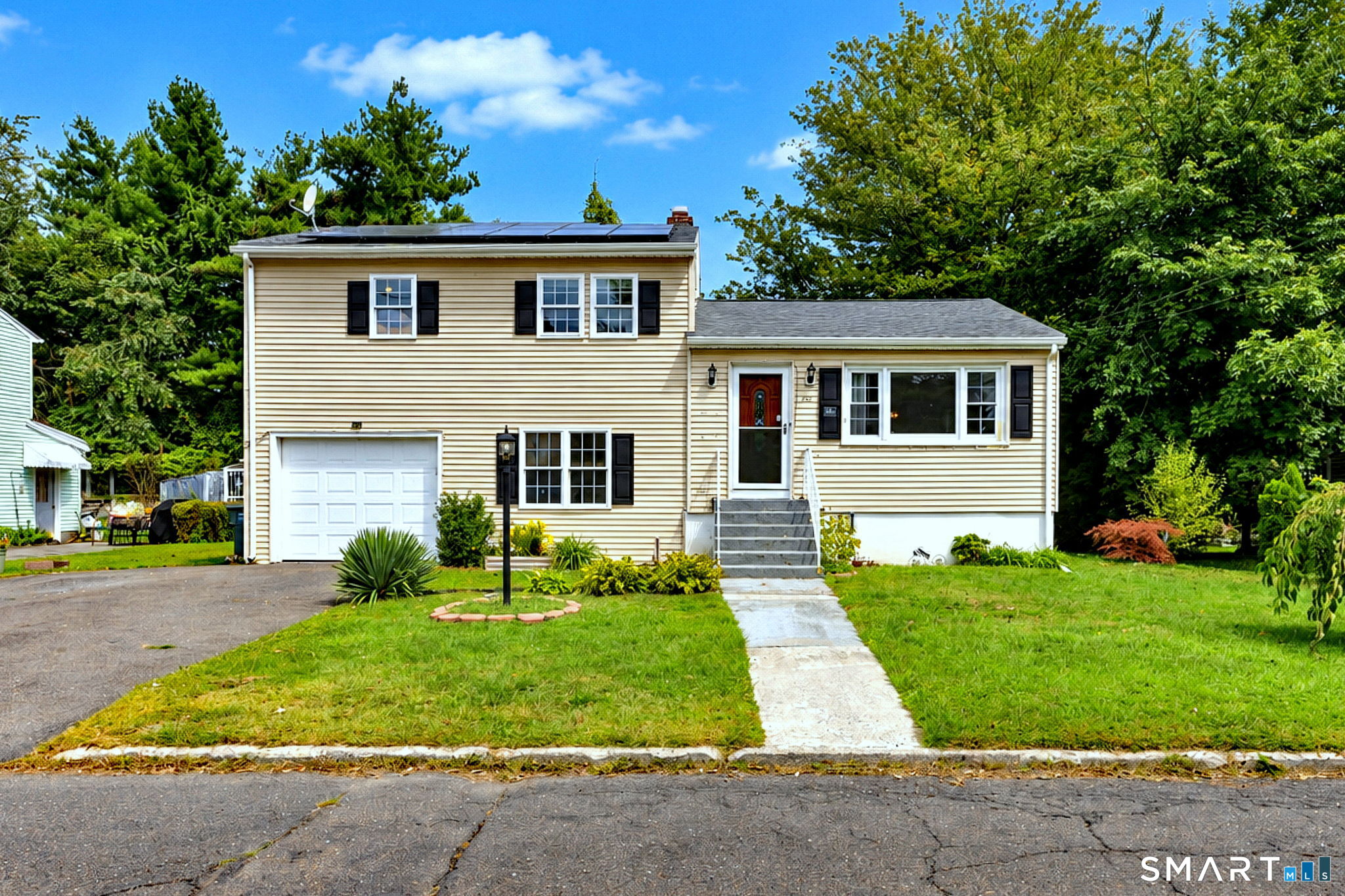 Welcome to this beautifully updated 4-bedroom, 2-full-bath split-level home, ideally situated on a quiet cul-de-sac in Bridgeport's desirable North End, just steps from the Trumbull line. Offering three levels of living space, this inviting home features an open-concept floor plan, gleaming hardwood floors and an abundance of natural light.The main level offers a spacious living room with a large picture window, designated dining area and remodeled kitchen featuring a large island and stainless-steel appliances. Step directly from the dining area onto the covered deck overlooking a beautiful, level, fenced-in and private backyard-the perfect setting for relaxing and entertaining.Upstairs you'll find 3 bedrooms, hardwood floors and a spacious remodeled full bath. The finished lower level provides even more flexible living space with a fourth bedroom that can easily serve as a home office, den or rec room. This level also features a second remodeled full bath with a walk-in shower, a convenient laundry/mudroom area offering direct access to the backyard and garage. A lower large unfinished basement and an extra storage room with walkout access is located behind the garage, Enjoy energy-efficient solar panels and newer mini split-system providing heating and cooling. A convenient location close to Trumbull Mall, Sacred Heart University, Merritt Parkway, dining, shopping, medical facilities, transportation and area amenities!