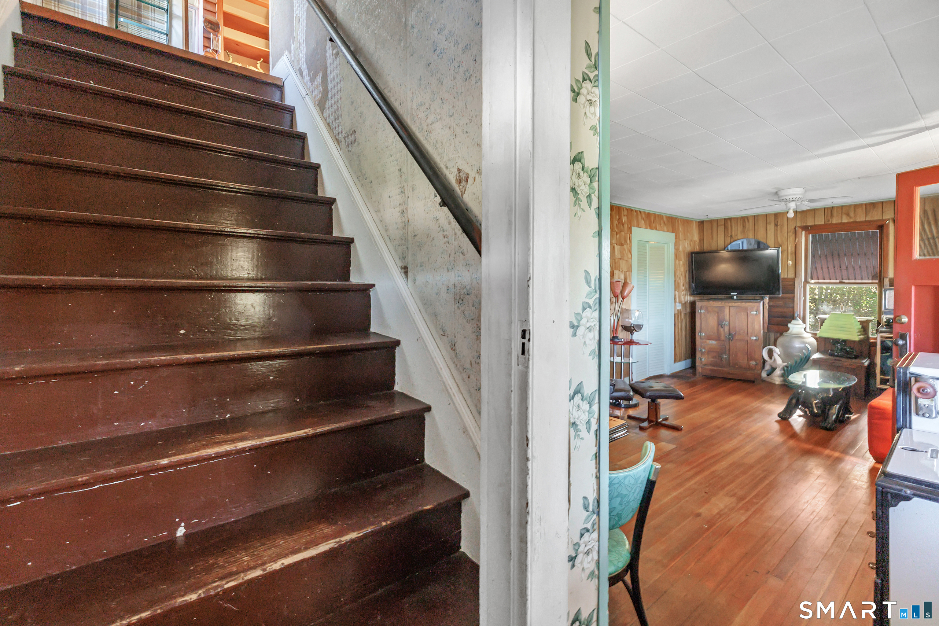 Main Floor - View of Living Room and wooden staircase that leads upstairs