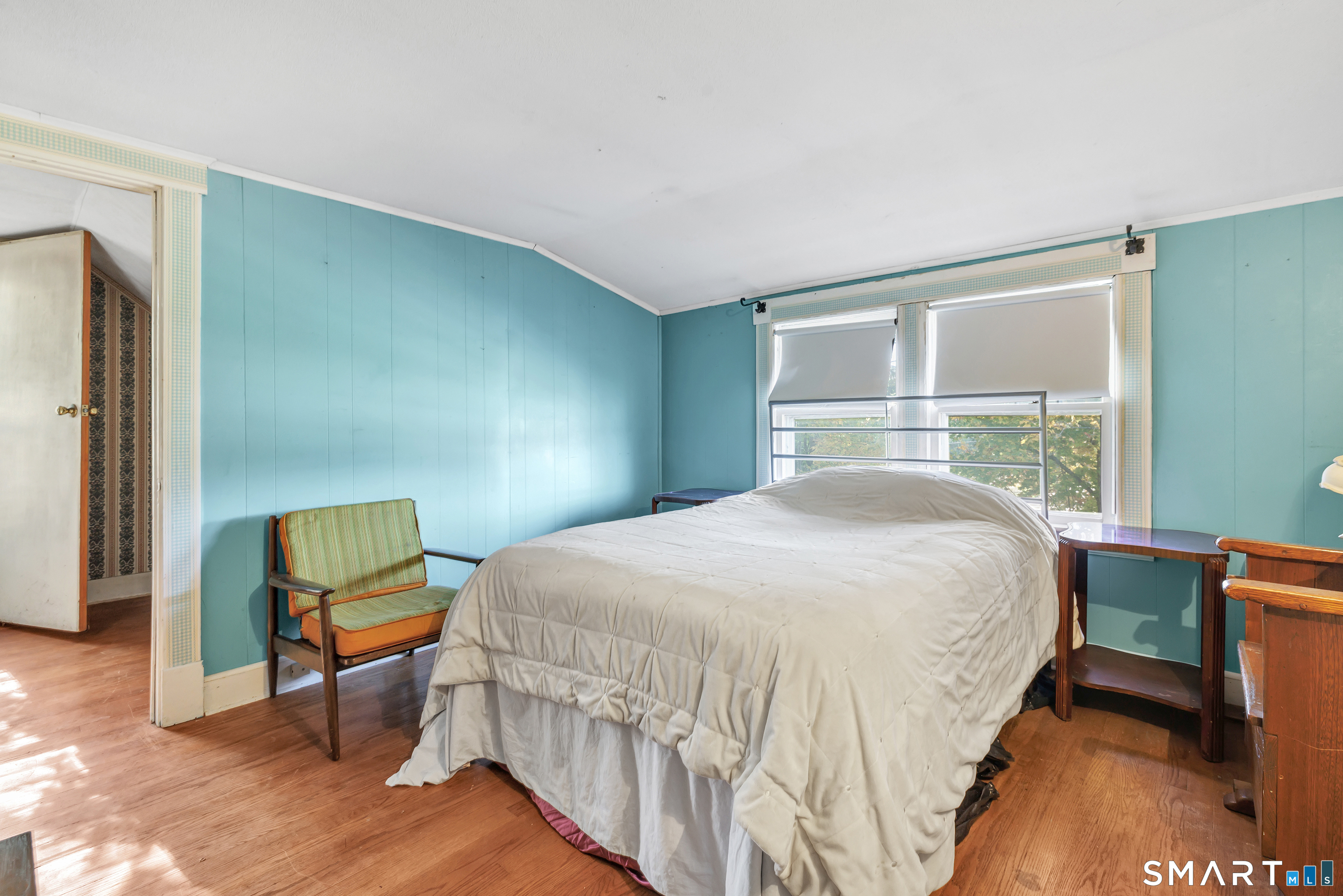 Upstairs - Primary Bedroom has a bonus room that can be used as a home office leads onto wooden deck.