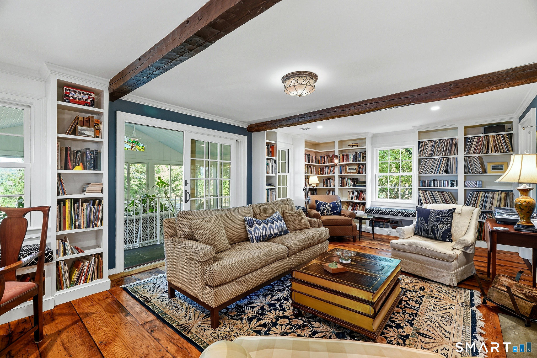 Library with built in window seats, bookshelves and fireplace with wood insert