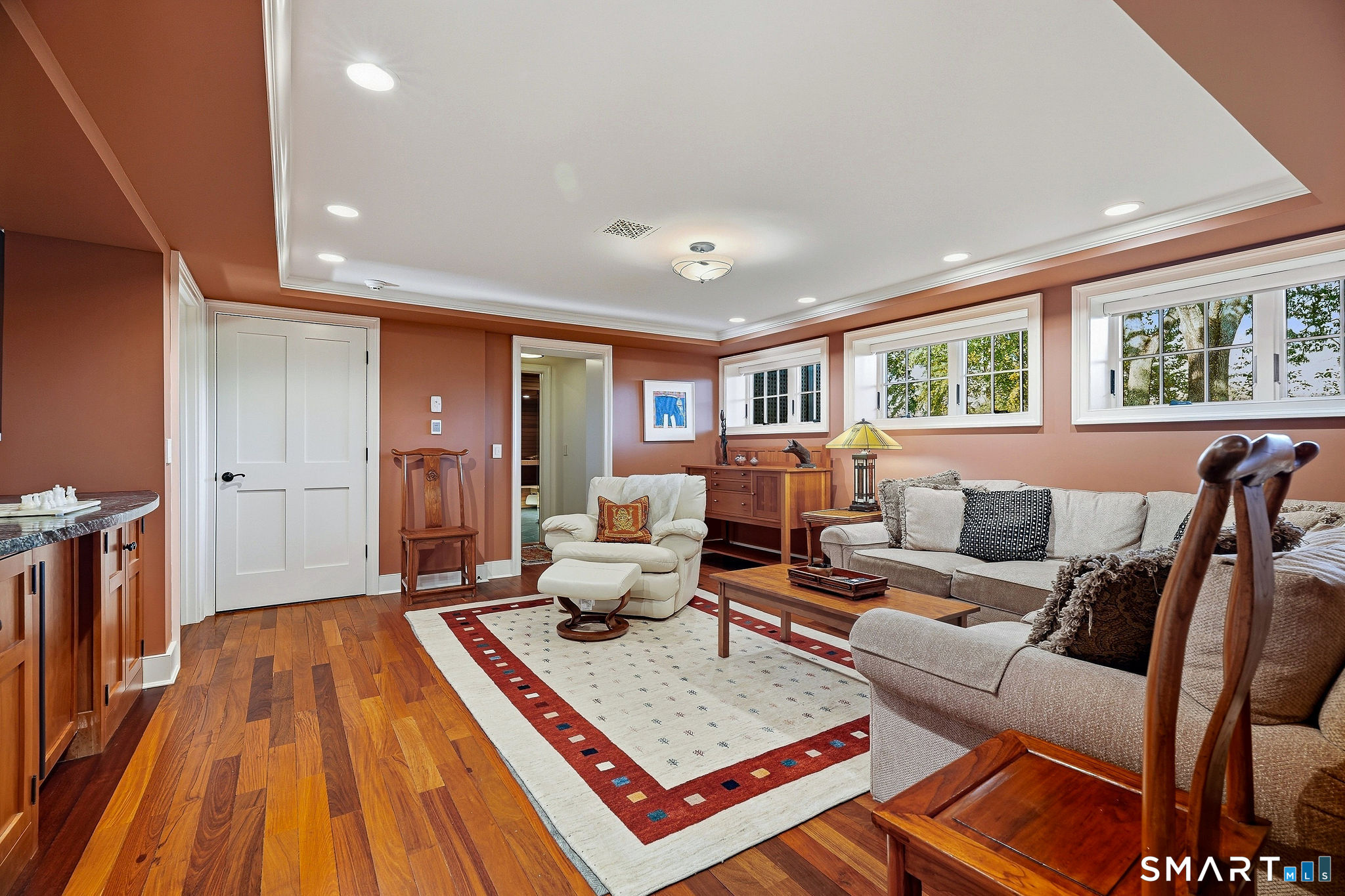 The first level is completely re-created beginning in the media room with dry bar and refrigerator. Find custom millwork and built ins throughout