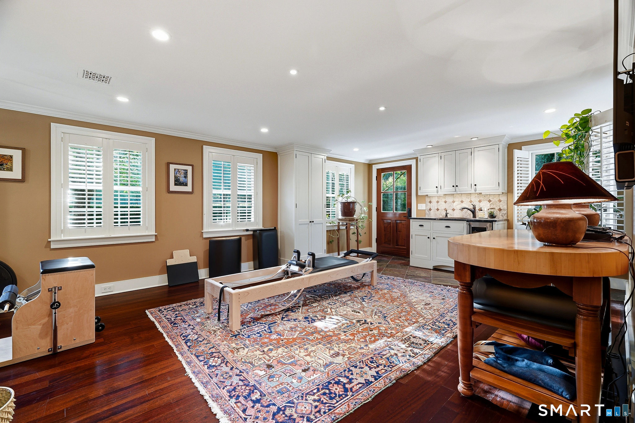 The game/exercise room with wet bar offers easy access to the south patio