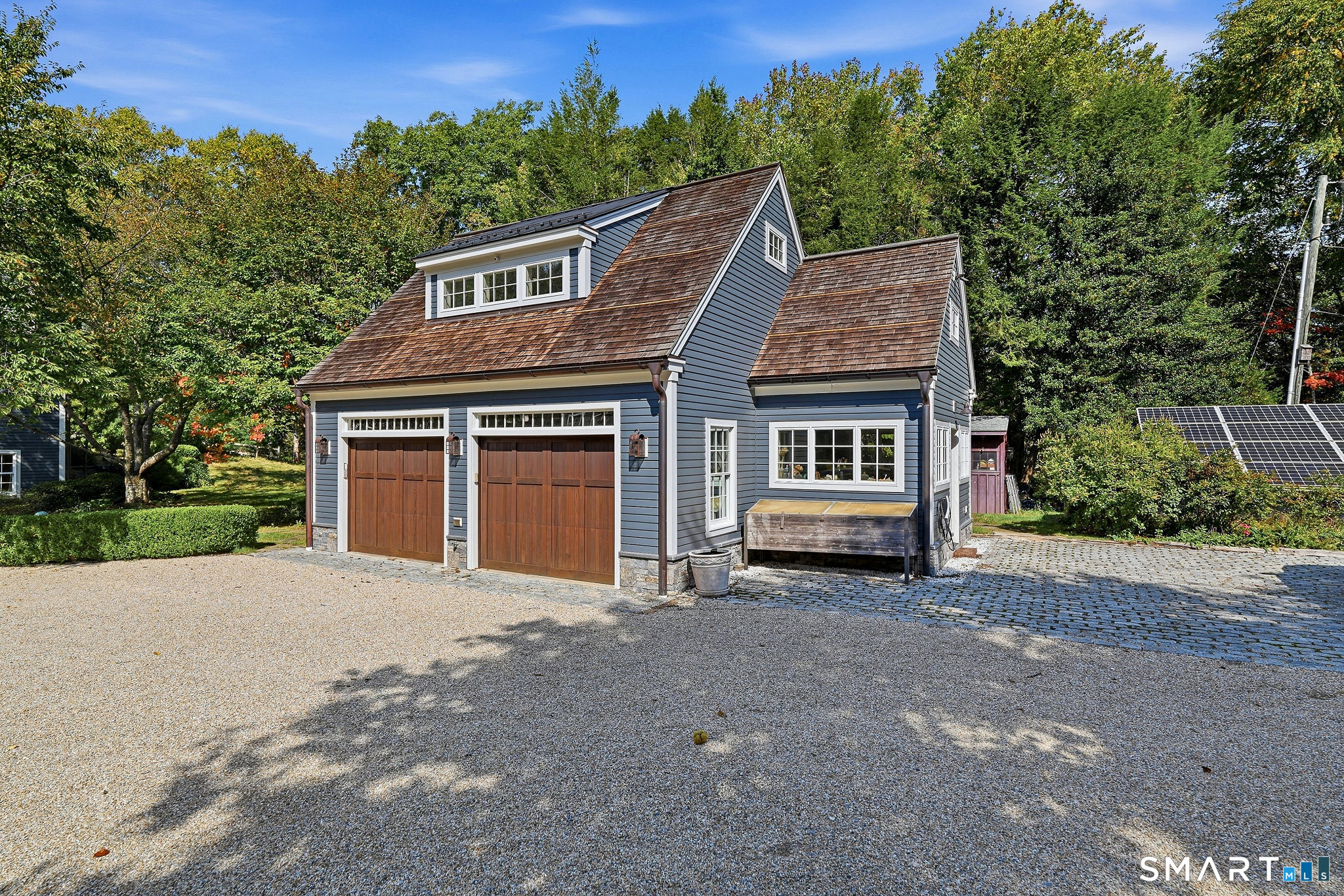 The carriage house. Plans for second floor living quarters available for review. Currently, the space is heated with additional heated storage on the second floor. The integral potting shed area with massive stone sink offers hot/cold water.