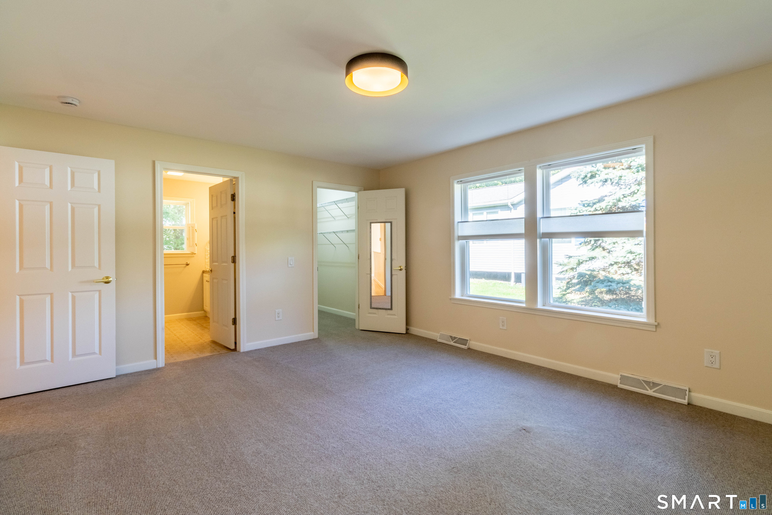 Primary bedroom with full bath and walk-in closet