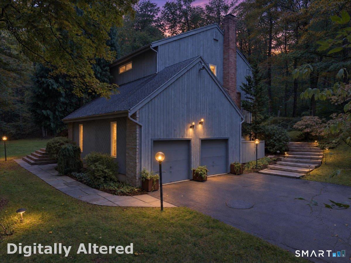 Welcome to a true Guilford sanctuary. A contemporary gem tucked away on 2.2 private acres featuring a large flat yard and a babbling brook traversing the front of the property. Step inside to discover dramatic cathedral ceilings and skylights in the entry and living room that create an airy, gallery-like expanse. With over 3200SF of livable space and storage galore, this is a home ready to showcase your art, books, and treasures from around the globe. The light-filled main level flows effortlessly through spacious living, dining, kitchen and TV room with a fireplace. With 3 sets of sliders out to an expansive gated back deck that runs the entire length of the house, there is a perfect view to watch the four seasons unfolding through your private woods. Upstairs, the sweeping primary suite is a true respite. It boasts a vaulted ceiling, adjoining sitting room, balcony and a spa-inspired bath complete with marble countertops and a soaking tub. Two additional bedrooms share a full bath. For those who work, write, or create, the renovated walkout basement is a revelation-a stunning custom library and office space with cozy propane heat and a half-bath that captures the academic soul of the home.  Located a short walk to Bittner Park yet remaining just a short drive to 95, you get absolute woodland tranquility without sacrificing convenience. Move in, celebrate the first snowfall in your new Guilford home, and write this remarkable property's next beautiful chapter.