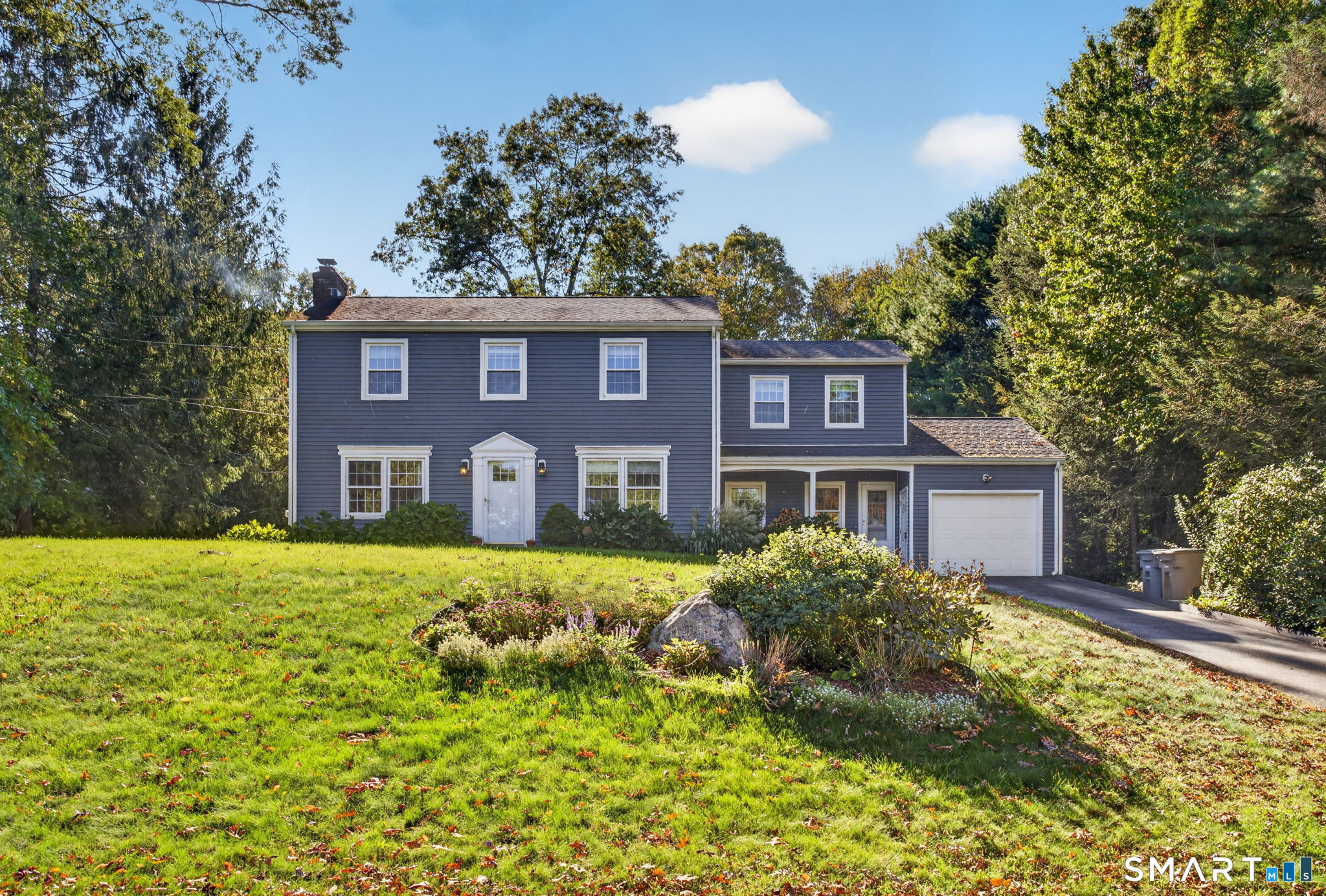 Welcome to this beautifully maintained 2,200 sq. ft. Colonial in a terrific East Lyme neighborhood! Just steps from everything East Lyme has to offer, this 4-bedroom, 2.5-bath home feels like new from top to bottom.  The inviting interior features beautiful hardwood floors, a unique eat-in custom kitchen with built-ins, granite countertops, and stainless-steel appliances. The first floor offers a comfortable living room, family room, and formal dining room, providing plenty of space for everyday living and entertaining.  Recent updates include beautiful vinyl siding, replacement windows, a high-efficiency propane boiler with indirect hot water storage, and a 2014 septic system. The primary suite features a newly updated bathroom with a custom shower.  Additional highlights include a full basement and full walk-up attic, offering abundant storage and potential for future use. Outside, enjoy a large, private rear yard-perfect for entertaining, relaxing, and enjoying the outdoors.  Solar panels are leased and are currently locked in at $52 per month with a modest annual increase.