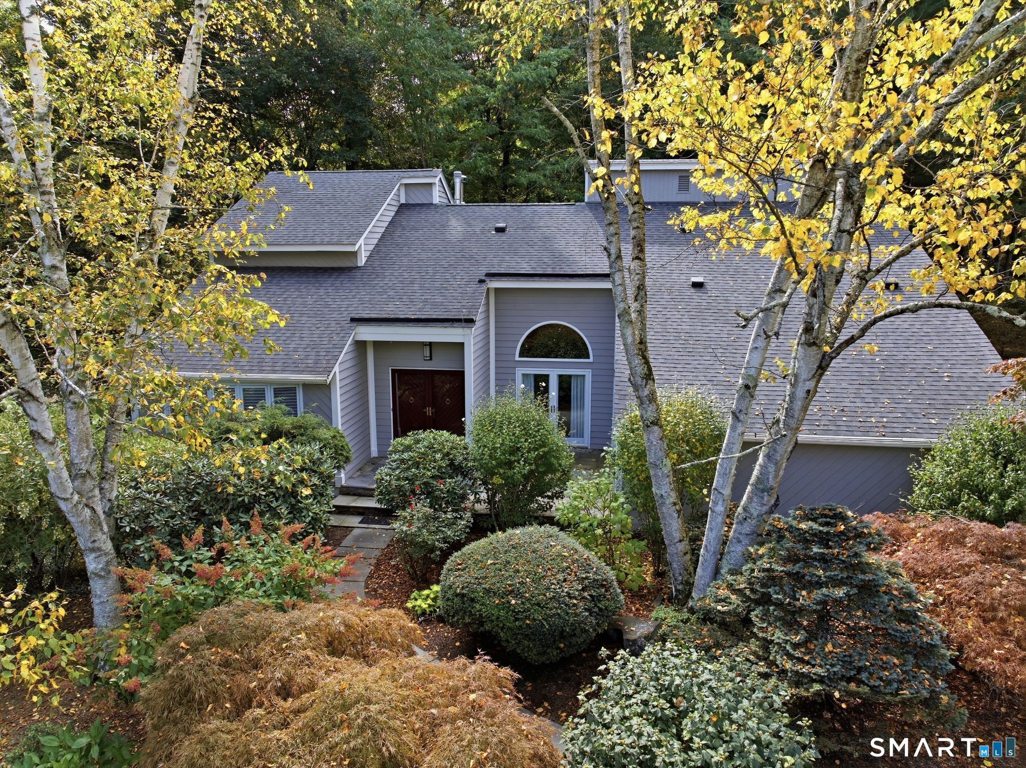 A beautiful contemporary design, lush landscaping and primary suites on both levels make this High Hill home a distinctive retreat, near the W Hartford line. Set on nearly an acre, the residence combines light-filled interiors with thoughtful & luxurious updates. Soaring ceilings, skylights, hdwd floors and generous french doors are perfect for everyday living & superb entertaining. Gather around the family room fireplace, host dinner in the sunken dining room or enjoy a quiet moment in the formal library. In the remodeled kitchen you will find white cabinetry, quartz countertops, SS appliances & an adjoining bkfst area. A first-floor primary suite offers exceptional flexibility. Currently used as a professional office space, it is a true main-level primary bedroom suite. Upstairs, a very spacious second primary suite truly brings the spa experience home with a Kohler digital shower system with multiple shower heads, steam, a radiant-heated floor and a large bubble tub. Rounding out the home is a lower-level walk-out space, offering add'l room for recreation. Improvements to the home incl a whole-house generator installed in 2021, furnace and AC replaced in 2020, a new water heater in 2026, skylights replaced in 2023. An oversized 2-car garage and underground sprinkler add everyday convenience. And enjoy the outdoors as the property lies nestled between Auerfarm & the MDC Reservoir recreation area. High Hill homes rarely go on the market, and this one is sure not to last!