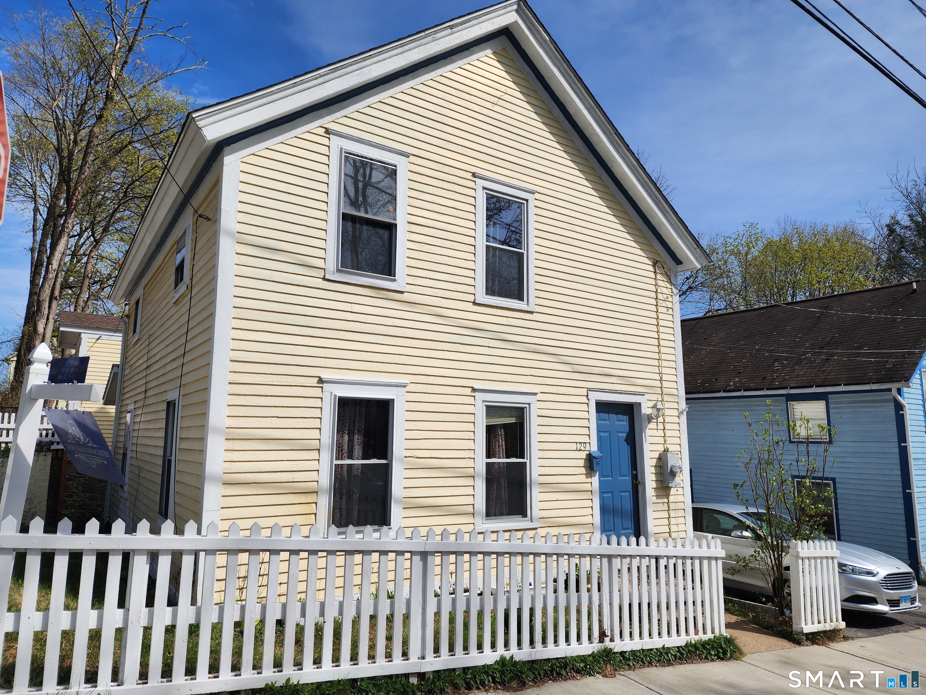Charming Antique Colonial - Prime Windham Location Step back in time and experience the warmth and character of this classic 1915 Antique Colonial, beautifully situated on a desirable corner lot in Windham. This inviting home offers four spacious bedrooms and one full bath, along with a generously sized living room perfect for relaxing or entertaining. The bright eat-in kitchen provides a welcoming space for gatherings and everyday living. Enjoy peaceful mornings or cozy seasonal evenings in the sun-filled three-season room, complete with stairs leading directly out to the backyard. The property is surrounded by a charming white picket fence, enhancing its timeless New England appeal. A standout feature is the impressive two-story garage with access from two streets, offering exceptional convenience, storage, or potential workshop space. The full walk-out lower level adds additional functionality and flexibility. Ideally located close to local colleges, this property presents an excellent opportunity for investors, owner-occupants, or those seeking rental potential. Enjoy nearby delicious eateries, unique shops, and easy commuting access to surrounding towns and major routes. This is a truly charming and classic New England home that must be seen to be fully appreciated.