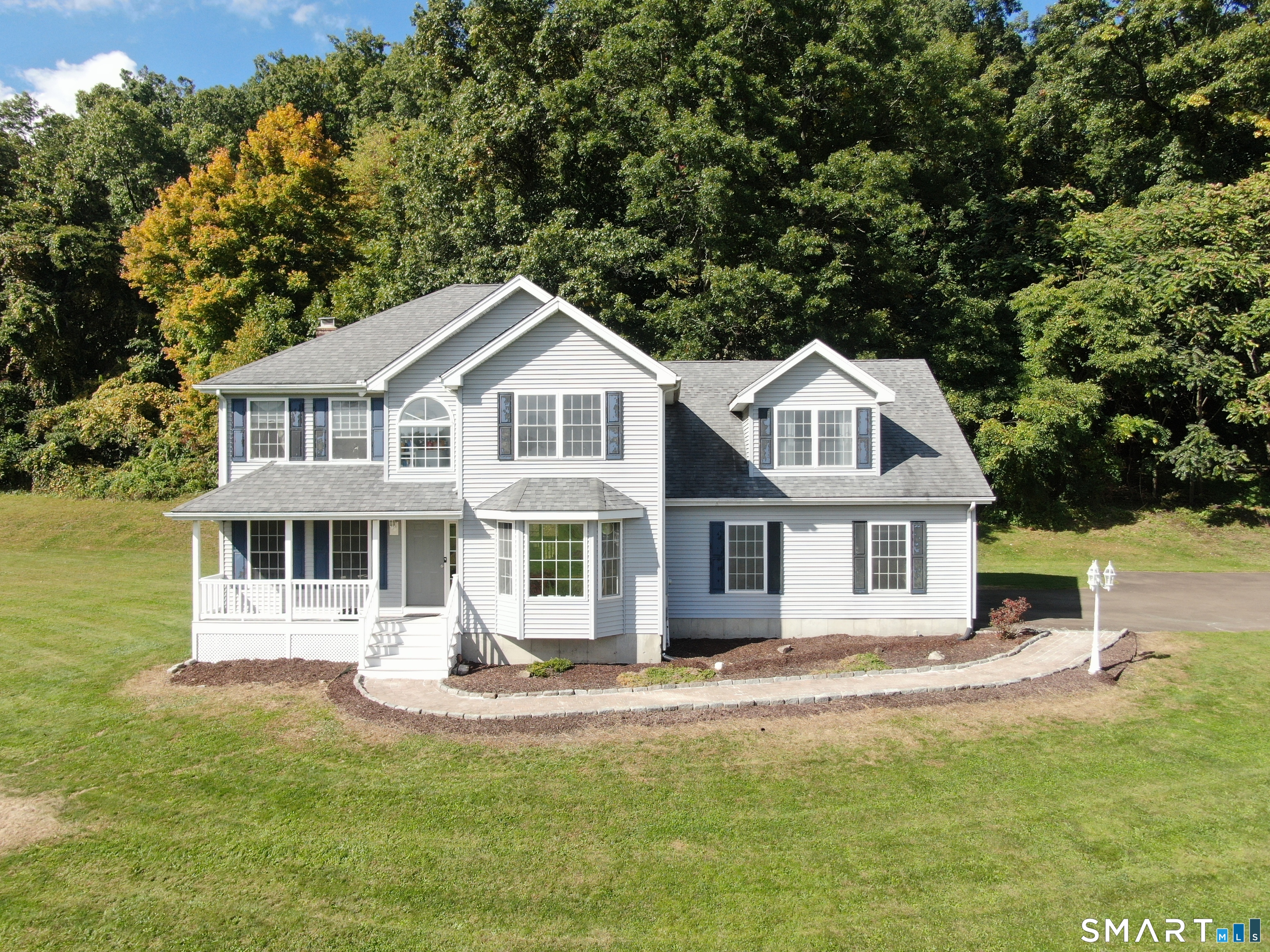 A Hidden Masterpiece of Privacy & Panoramic Vistas over Totoket Valley! Tucked away at the end of a long sweeping driveway in Northford's prestigious Autumn Court enclave, this 2,650 square foot hidden gem offers a spectacular, elevated residential oasis. Positioned deliberately on its stunning, expansive 1.5 acre interior lot to maximize nature rather than the street, this home was custom-oriented to capture breathtaking, unobstructed panoramic views of the historic Totoket Valley and the dramatic ridgelines of Totoket Mountain from almost every window of this 4 bedroom, 2.5 bath colonial. The 4th bedroom is in the spacious dormered Bonus room which is currently used as a home gym and would make a wonderful playroom or home office. Updates over the years include new roof, furnace, water heater, oil tank, well pump and garage doors. there is a deck off the kitchen overlooking the expansive level lawn with room for a pool and pool house and a lovely front porch to enjoy the views.  The structural bones, elite location, and sheer footprint offer an unparalleled canvas. For the visionary buyer this is a rare chance to design your dream interior while instantly stepping into substantial equity in a neighborhood where neighboring homes command up to $850,000. Bring your design ideas and unlock the true luxury potential of this magnificent property. Schedule your private tour today to experience the view for yourself on this spectacular property.