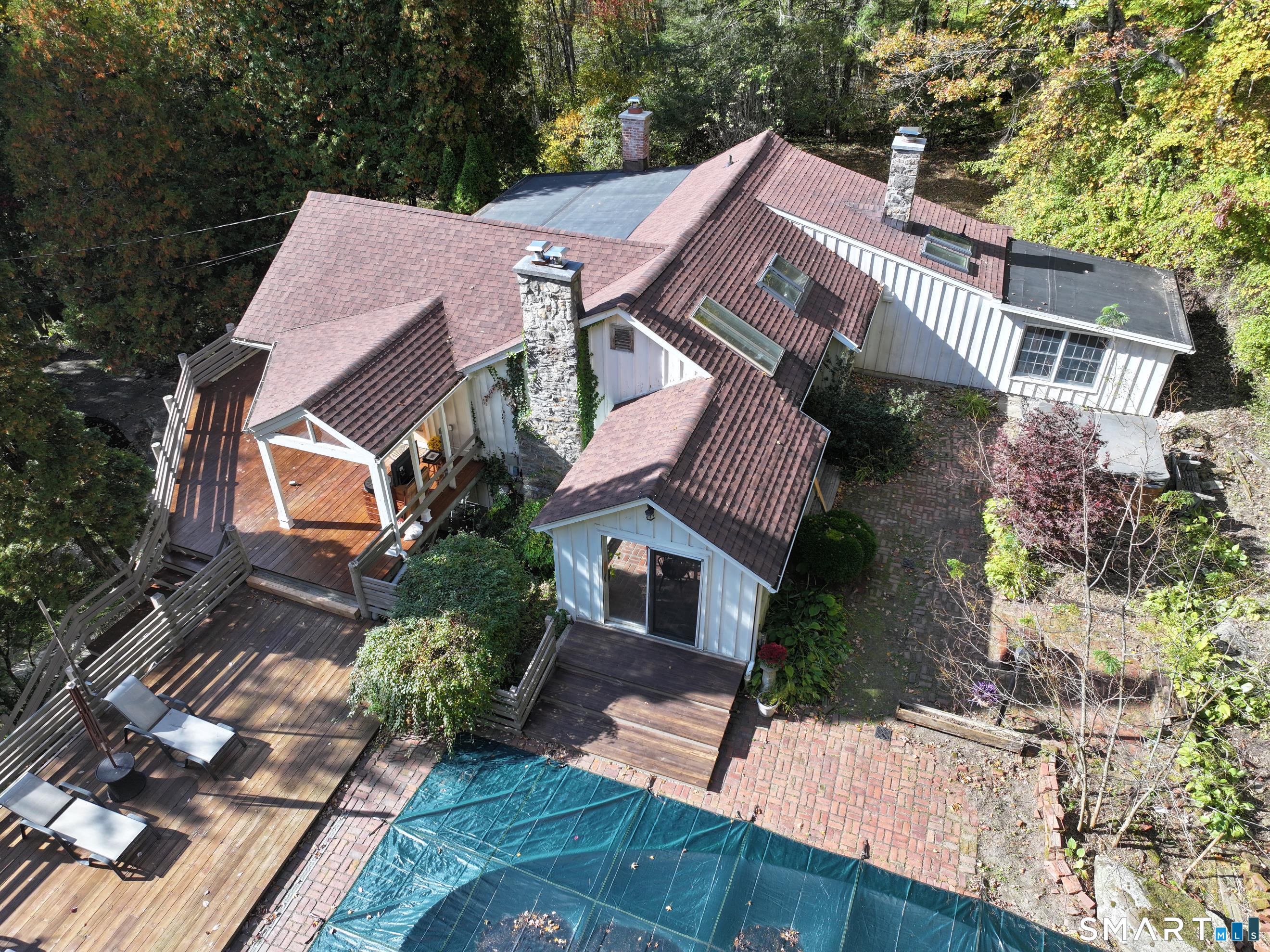 Magical setting and so much character, uniqueness and potential! 3 bedroom 3 bath 3 fireplace contemporary home on private 2 plus acre lot with inground pool and ponds. 2 car detached garage. Living room with vaulted ceilings, hardwood floors, beams, walls of glass and fireplace. Vaulted eat in kitchen with skylite and brick floor and breakfast bar. Super cool den with fireplace, loft, brick floor and great windows. Primary bedroom with distressed pine floors, walk in closet and full bath. 2 sets of stairs to the lower level (one spiral) where you will find an awesome family room/gameroom with slate floors, fireplace and bar plus 3rd bedroom. The outside has indefinite potential and character. Spring fed ponds with patios and walking bridges and dock. Perfect weekend retreat or year round paradise! Great schools and low taxes and minutes to the train station!!
