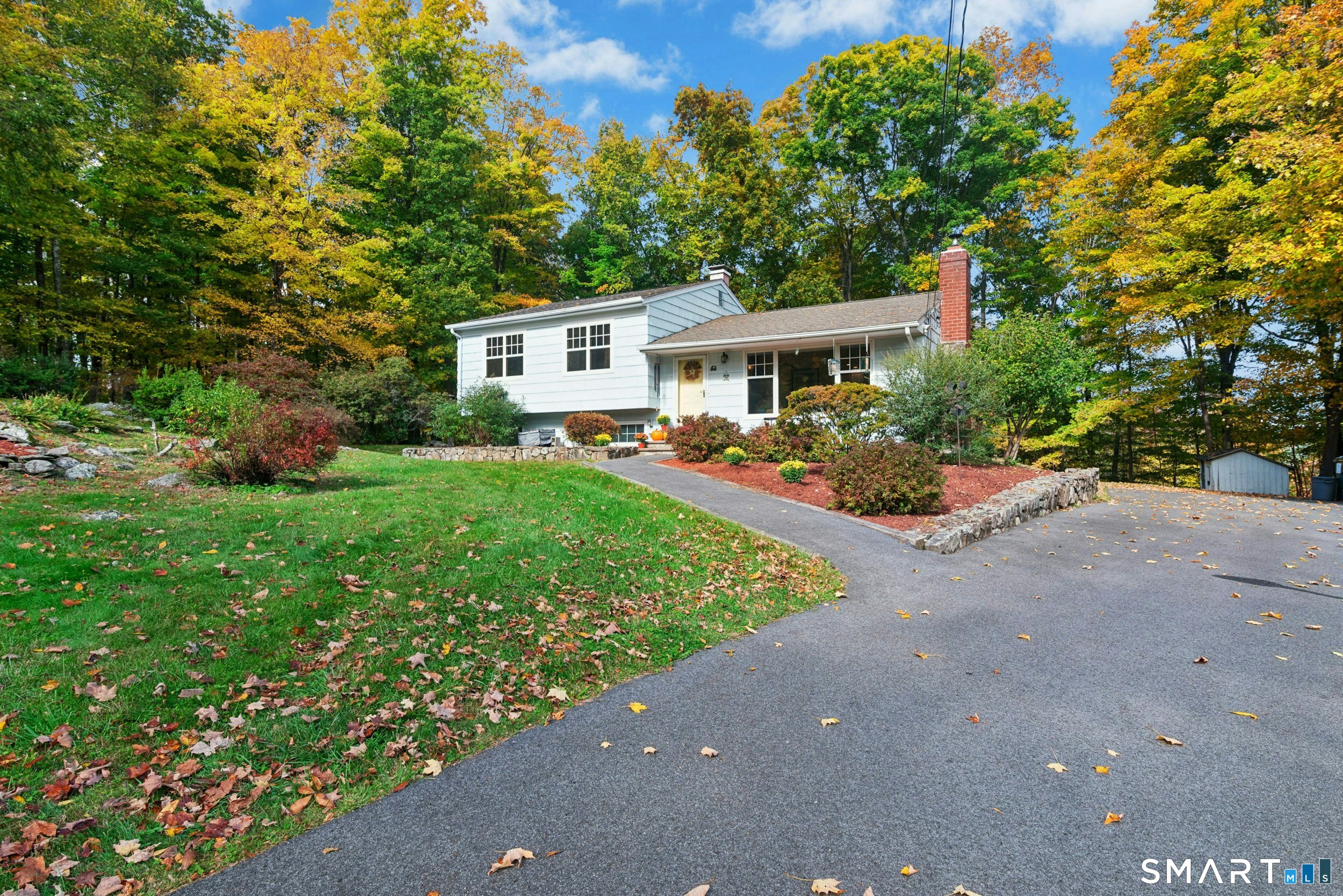 Welcome to 35 Aspen Levels Road. Perfect weather you are looking to downsize or upsize, this turnkey 3-bedroom split level home sits on a private, beautifully treed 1 acre lot in desirable Ridgefield, Connecticut. Reflecting true pride of ownership, the light filled layout features hardwood floors and an effortless open concept centered around an updated kitchen with granite countertops and white appliances, and breakfast bar seating. Relax in the inviting main Livingroom with fireplace or head downstairs to the huge walk out lower-level family room, laundry with half bath and storage. Updates include driveway, roof, windows replaced, bathroom, kitchen, 200-amp, CENTRAL AIR, furnace and generator wired to endure absolute peace of mind. Minutes from Downtown with shops, fine dining, hiking rails and major commuting routes. This completely move in ready home offers an extraordinary lifestyle in in a setting you will love coming home to every day.