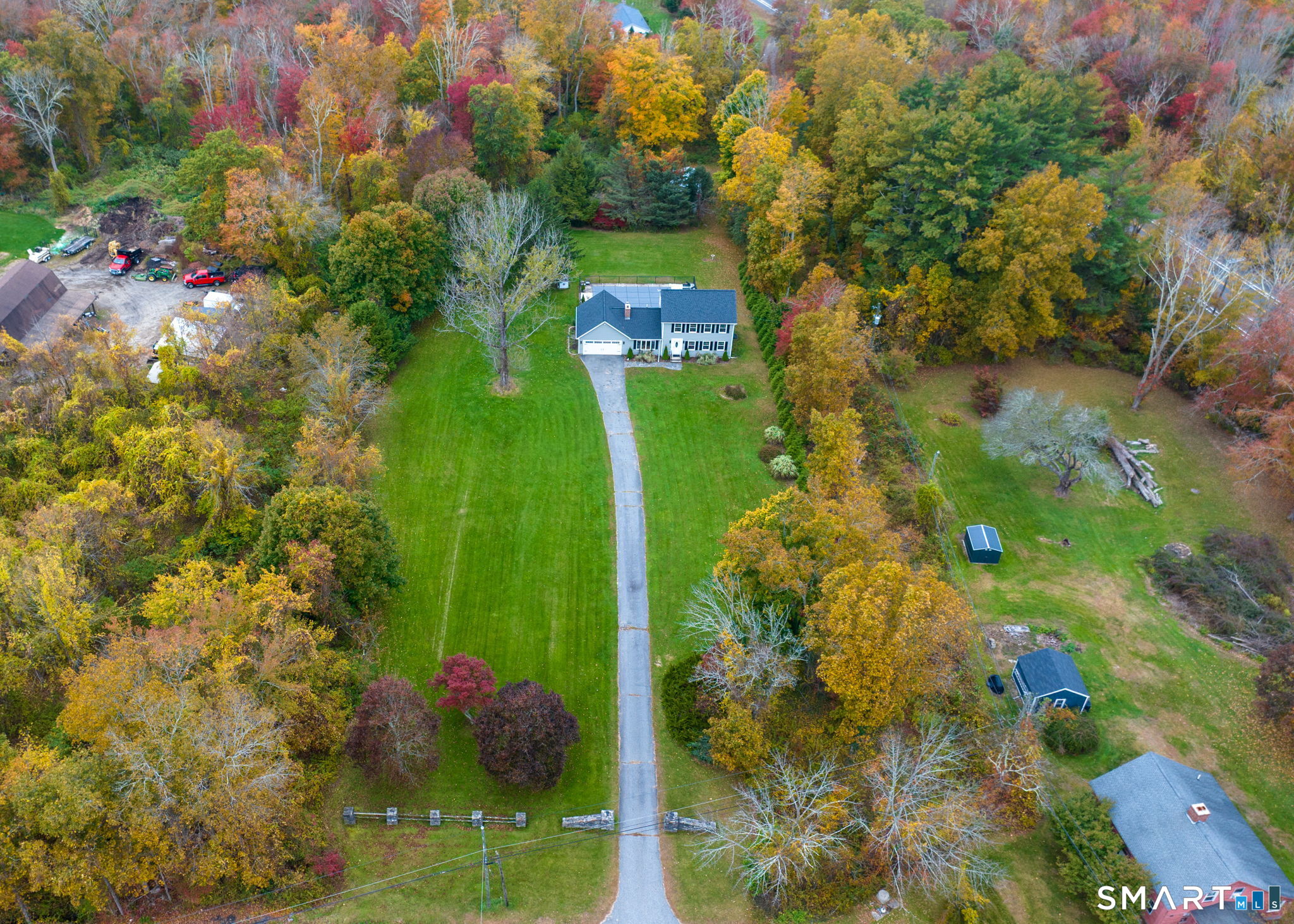 Discover the charm of Connecticut's Quiet Corner! Set on a beautiful, level 5-acre lot, this spacious modern colonial home offers the perfect blend of privacy, recreation &convenience. Located in one of Connecticut's oldest settled communities adjacent to Rhode Island, the area is part of the Last Green Valley National Heritage Corridor and was once known as the "Curtain Capital." This move in ready home features a spacious open floor plan. Kitchen-dining area combination with sliders to deck overlooking beautiful backyard and pool, updated kitchen with granite counters and plenty of cabinetry, fireplaced family room with bow window allows lots of natural light and a large living room provides extra space for entertaining during the holidays. Upstairs features 3 generous sized bedrooms with ample closet space and 2 baths. An oversized 2-car garage provides additional storage, while abundant off-street parking accommodates boats, RVs, trailers and other recreational vehicles. Enjoy easy commuting to Providence via Route 6, or Worcester and New London via I-395. The property is an outdoor oasis featuring an inviting in-ground pool, patio and deck areas perfect for summer entertaining. Think ahead! In winter, the expansive acreage offers plenty of room for ATV fun and outdoor recreation. A rare metal outbuilding with electricity, overhead door and possible access to Route 6, is ideal for collector cars, motorcycles, equipment, workshop space or other hobbies.