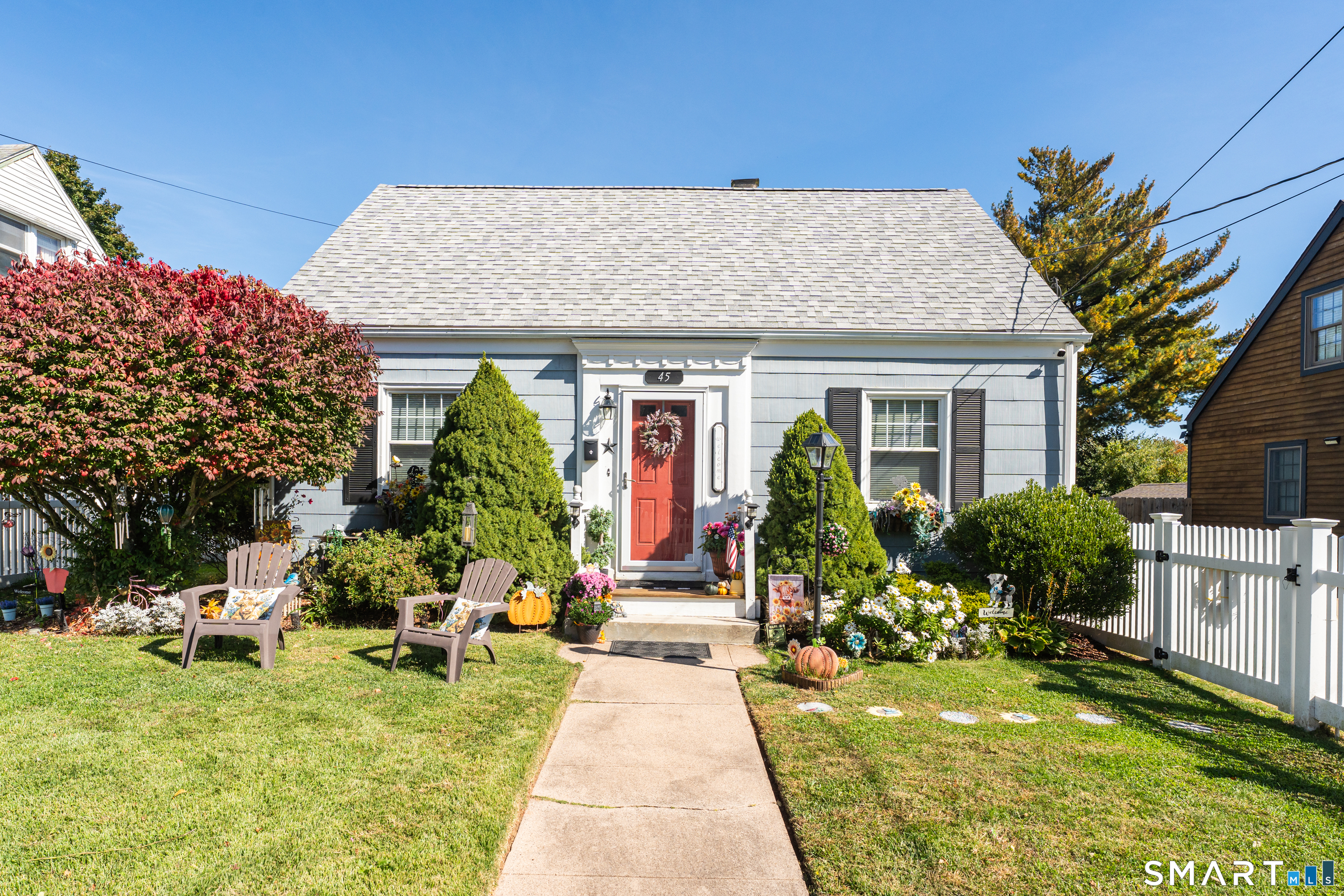Storybook charm meets easy, one floor living in this picture perfect Cape, centrally located in Hamden between Whitney and Dixwell Avenues and convenient to all major highways. From the white picket fence to the beautifully kept facade, this home welcomes you the moment you arrive, and it only gets better inside. Gleaming hardwood floors run throughout a bright, inviting layout. The living room and separate dining room offer classic, comfortable spaces, while the kitchen shines with granite counters and flows into a sunlit sunroom, the perfect spot for morning coffee. A main floor primary bedroom and full bath make everyday living a breeze, with two additional bedrooms upstairs for guests, family, or a home office. Step outside to a backyard built for gathering: a large Trex deck, a patio with a built-in firepit, and a level, spacious yard with room to roam, plus a handy shed for storage. It is private, low maintenance, and ready for everything from quiet evenings to summer cookouts. Downstairs, two separate finished areas in the basement add flexible bonus space for a rec room, gym, or hobbies. Modern comforts are all here: gas heat, central air, an alarm system, newer vinyl windows, and a new roof (2021). Nothing to do but move in and enjoy. Homes with this much heart and this little upkeep do not last, so come see it before it is gone.