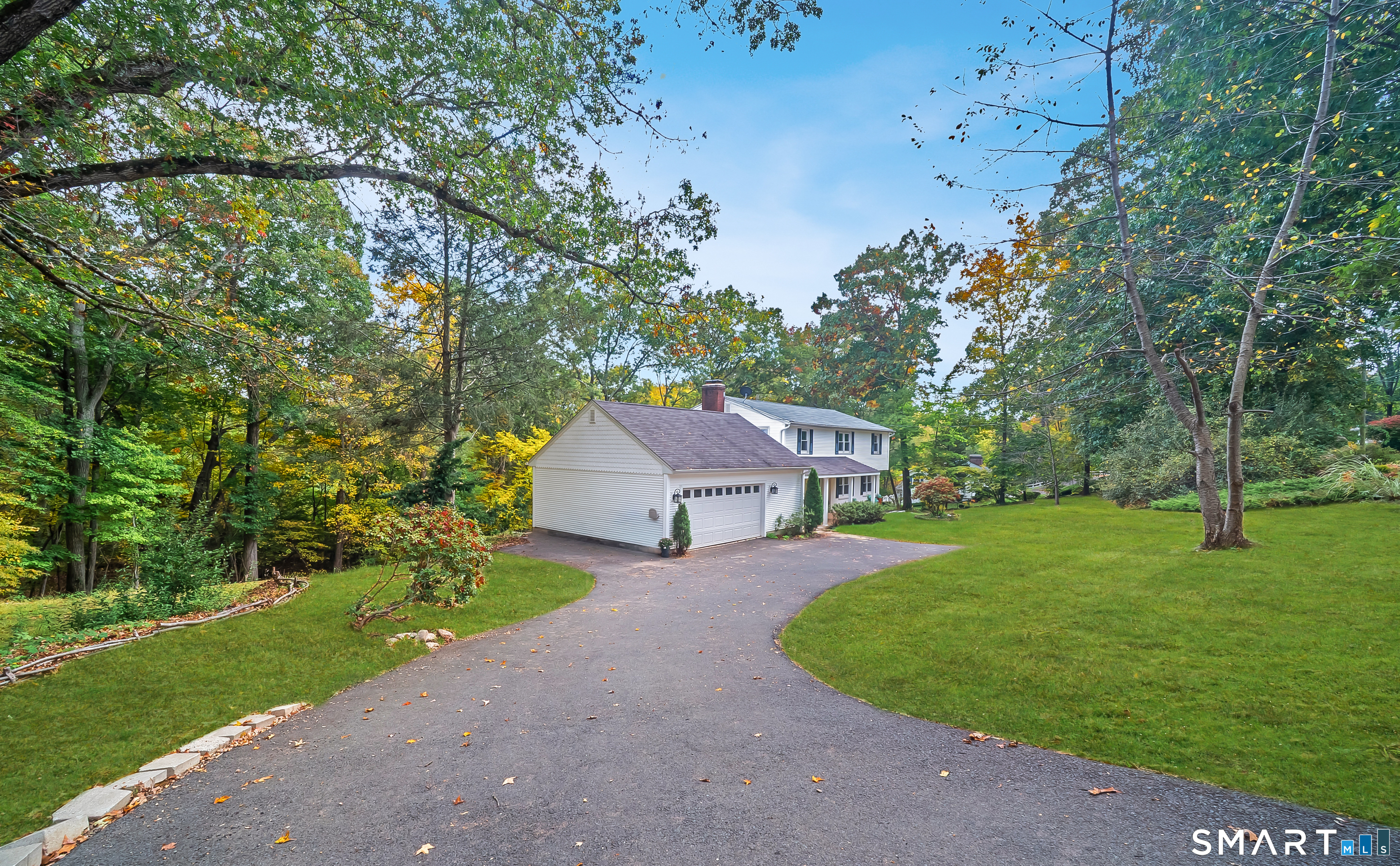 Spacious Colonial with In-Law Potential, a walkout lower level & a peaceful river setting! Enjoy the privacy, space & tranquility of this 5-bedroom, 3.5-bath Colonial nestled on a tree-lined lot, where the soothing sounds of a nearby flowing river create a peaceful backdrop. This home offers generous room sizes, abundant nat'l sunlight & versatile living space for the whole family. The spacious eat-in kitchen features granite counters & an abundance of cabinetry. Off the kitchen, a wonderful 4 season sunroom, a perfect place to unwind & take in the peaceful surroundings, with direct access to the rear deck & backyard. A huge dining room & expansive living room with 1 of 2 fireplaces provide plenty of room for entertaining & everyday gatherings. Upstairs, retreat to the spacious primary suite, complete with a private full bath & walk-in closet. The 2nd full bath features a charming clawfoot tub & shower, perfect for relaxing at the end of the day. 3 add'l bdrms with abundant closet space complete the upper level. The walkout lower level offers even more possibilities, featuring a family room with its own fireplace, an add'l bedroom & full bath, an ideal setup for extended family & guests. The walkout provides convenient access to the outdoors. An oversized attached two-car garage adds convenience and storage. Add'l features-incld hdwd floors, updated C-air & 3 zone heating & is generator-ready. With its generous space & flexible layout, come make this home your own!