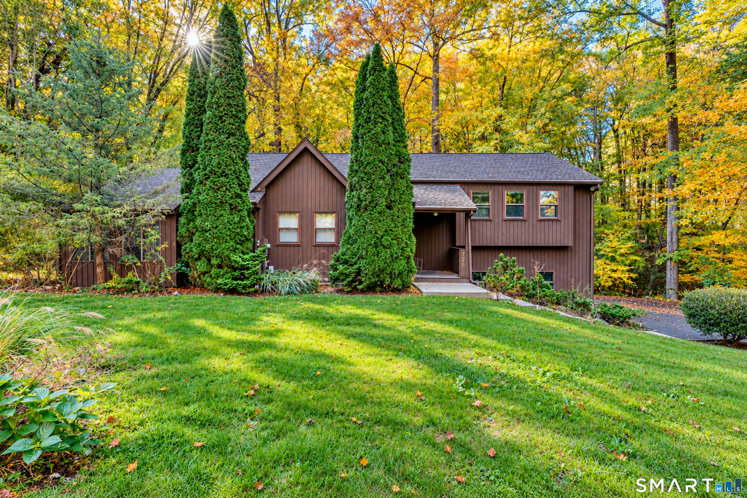 Two primary suites, multiple living spaces, and a private wooded setting just minutes from the heart of Glastonbury! Set back from the road on 1.09 acres, this 4-bedroom, 3-full-bath split-level home offers the perfect balance of privacy and convenience. A standout feature is the TWO primary suites, each with its own full bathroom and walk-in closet, ideal for multigenerational living, extended guests, or anyone looking for extra space. Inside, vaulted ceilings, exposed wood beams, and warm natural wood accents create a cozy, inviting atmosphere. The eat-in kitchen features granite countertops, a center island, and a breakfast nook with access to the deck. The split-level layout offers plenty of room to spread out, with a spacious living room, a finished lower-level family room with a second fireplace, and a three-season porch overlooking the wooded surroundings. With 2,050 square feet of above-grade living space plus an additional 412 finished square feet below, there's flexibility for entertaining, working from home, or simply relaxing. Outside, enjoy the peaceful setting from the spacious deck with built-in seating, surrounded by mature trees and greenery. Complete with a level yard, paved driveway, and two-car garage, this home offers the feeling of a private retreat while remaining just minutes from Glastonbury's shopping, dining, schools, JB Williams Park, and Route 2. The best of both worlds-seclusion without sacrificing convenience!