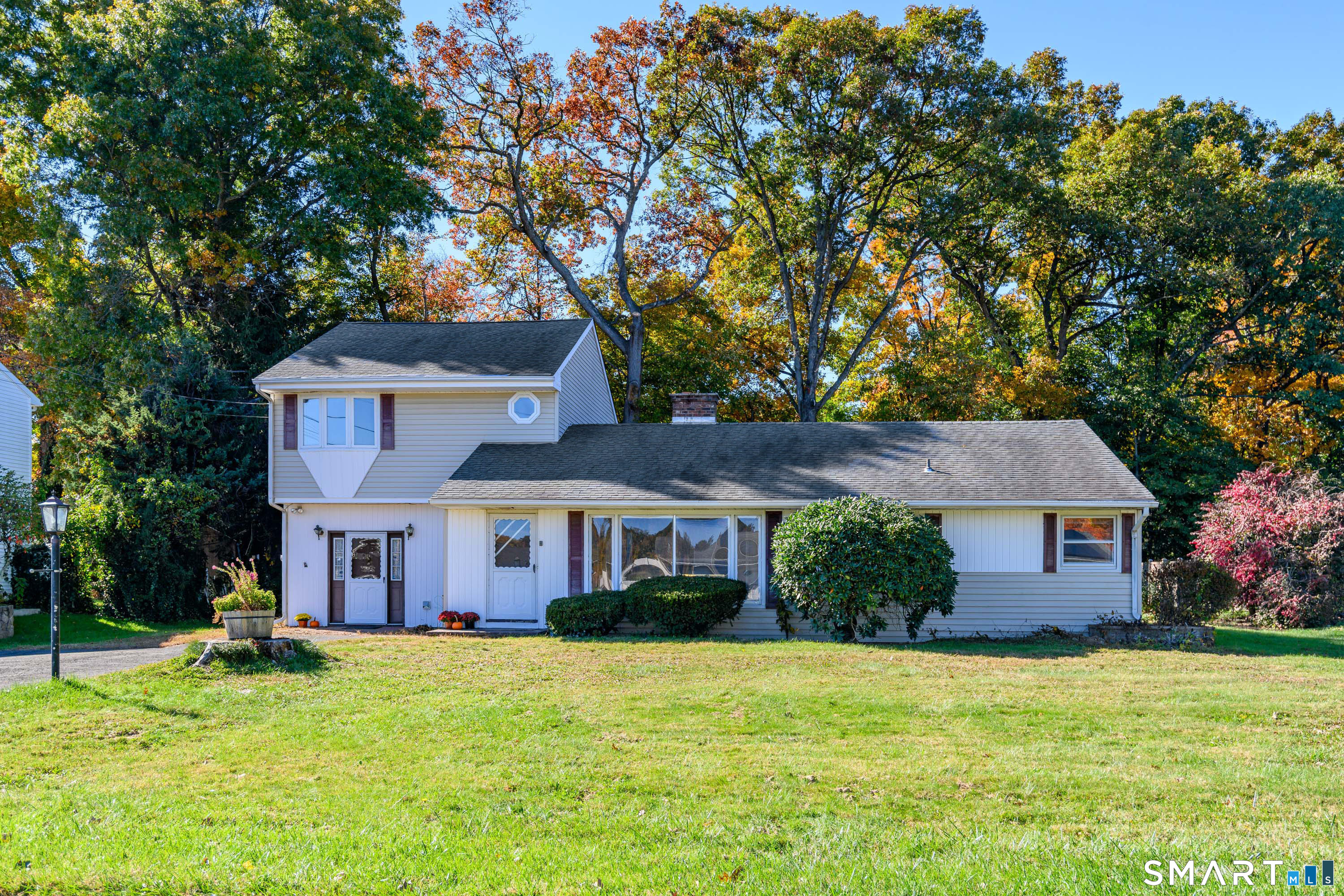 Welcome to 7 Apple Blossom Lane, a charming three-bedroom, two-full-bath expanded ranch offering generous living spaces, a level backyard and a fantastic location close to highways, shopping and dining. The main level features hardwood floors, two bedrooms and a full bathroom, along with a spacious living room anchored by a fireplace. A sunroom overlooks the backyard, providing an inviting spot to relax and enjoy the changing seasons. An additional den offers flexibility for a home office, hobbies or everyday gatherings. Upstairs, the large primary suite creates a private retreat separate from the main-level bedrooms. The unfinished lower level provides ample storage and potential for future expansion, subject to necessary approvals. Outside, the level 0.35-acre property offers room for gardening, recreation and outdoor entertaining, framed by mature trees and established landscaping. With approximately 2,131 square feet, this home presents a wonderful opportunity to update and personalize while enjoying its space, setting and convenient location.