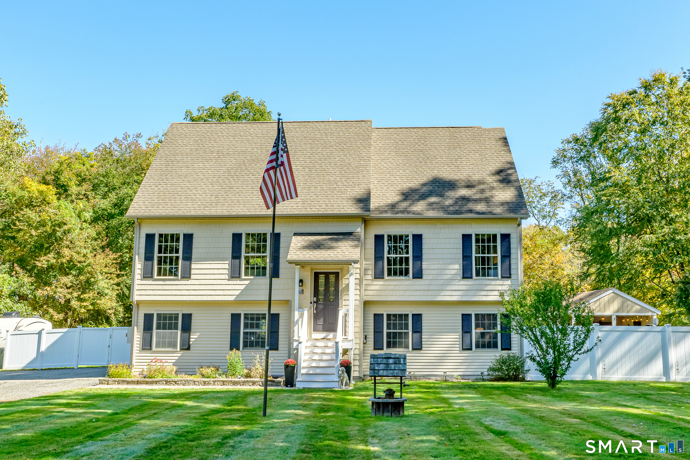 146 Kimball Road | Lisbon, CT  Welcome to this beautifully maintained Cape Cod-style home, offering nearly 2,300 square feet of thoughtfully designed living space on over an acre of picturesque grounds. With 3 bedrooms, 2 full baths, and 2 half baths, this inviting multilevel home offers an exceptional combination of comfort, functionality, and versatility.  Beautiful hardwood floors complement the spacious main-level living and dining areas, creating a warm and welcoming atmosphere. The updated kitchen features Corian countertops, a farmhouse sink, new appliances, and pantry, with convenient access to an expansive deck overlooking the backyard. A generously sized main-level primary suite offers a private bath and walk-in closet, while a dedicated laundry area adds everyday convenience. Upstairs, two spacious bedrooms feature generous closets, additional storage, and a shared Jack-and-Jill bathroom. The finished lower level offers endless possibilities for a second living area, home office, guest space, or potential extended living accommodations, with access from both the interior and attached two-car garage.