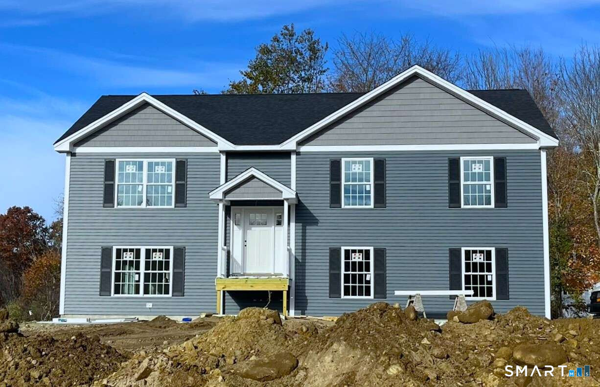 Welcome to this New Construction Raised Ranch Home, with an updated facade and side entry garage, this sturdy structure has been situated on a one acre parcel within a newly developed, private, four-lot subdivision. Act now to personalize your preferred colors and finishes. The development borders conservation land with Quaddick State Park and golf minutes away. Views from this hill sitting home will give the owner picturesque sunrises over Quaddick's Lower Reservoir Pond. This thoughtfully designed property features three bedrooms and three full bathrooms, an open floor plan with cathedral ceilings filling the space with natural light. The home is offered with a fully applianced kitchen, including a large center island for casual dining. The living space is complemented by lustrous hardwood floors throughout the main level. The finished walk-out lower level provides extra living space, perfect for entertaining or relaxing in the front to back sitting room. This level also includes a full bathroom and laundry room combo. Additional features include: Two-car garage, Central air conditioning, and a private, one-acre lot ideal for outdoor enjoyment, Potential expansion with Four Bedroom Septic System Installed. A stone's throw to the Massachusetts line and I-395. This home is a must-see for anyone seeking modern amenities and elegant finishes. Make your showing today and find this dream home yours!