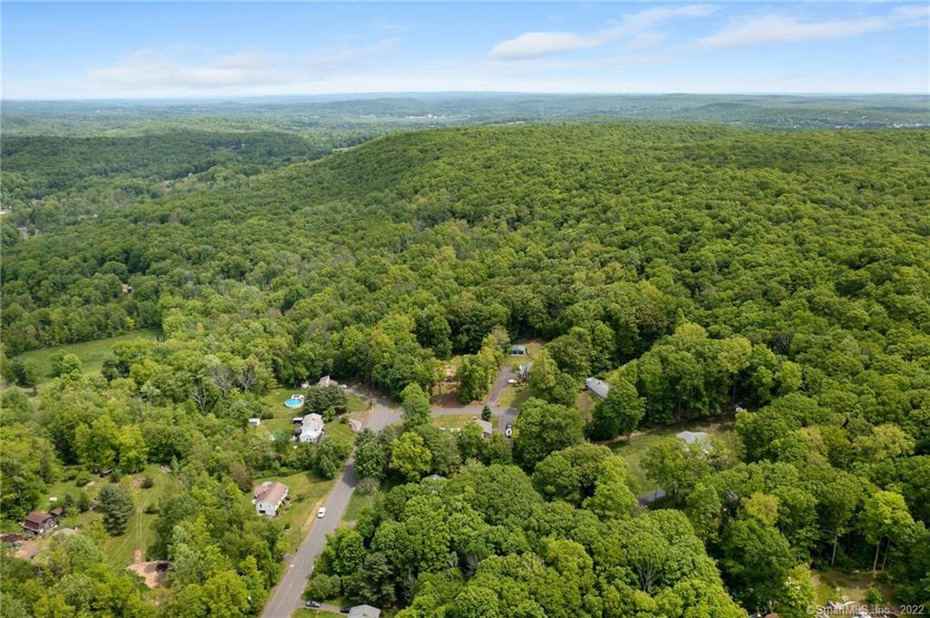 An opportunity that cannot be missed! Attention builders, developers and investors: Look no further, your next investment awaits. Scenic and breathtaking land opportunity offering 88 acres in Northford ( North Branford ) and an additional 5 acres into the town of Durham. This 90+ acres are located off Blue Jay Drive and Skylark Drive Cul-de sac a minute from Route 17 & 8 miles from Interstate 91 North and the Merrit Parkway. This natural filled wooded land is home to part of Mattabasset Trail ( A New England Trail) some streams and waterfalls. Public sewer & Wallingford Electric Division are provided to this area along with a magnificent New England location. Positioned just about in the middle of New York City and Boston Massachusetts, residents can also enjoy just a 30 minute ride to Connecticut's shore line/ beaches , a 25 minute drive to New Haven and a 40 minute drive to Hartford. With 500 feet of footage, this potential new home development can host one acre lots (provided necessary approvals). Zoning requirements indicate 2 acres to subdivide building lots however the past few sub developments and current sub developments in this township easily received approvals for 1 acre. The homes on Blue Jay drive and Skylark do have public sewer connected and some private wells but buyer is responsible for their due diligence on any and all matters. On the eastern portion of the property there is protected lands for trap Rock Ridge.