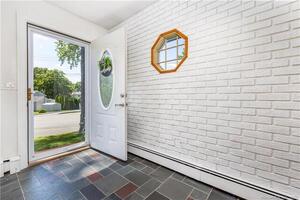The foyer is spacious w/ a slate floor and coat closet.