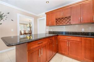 The remodeled kitchen features 42" cherry cabinetry w/ wine storage and bullnosed granite counters.