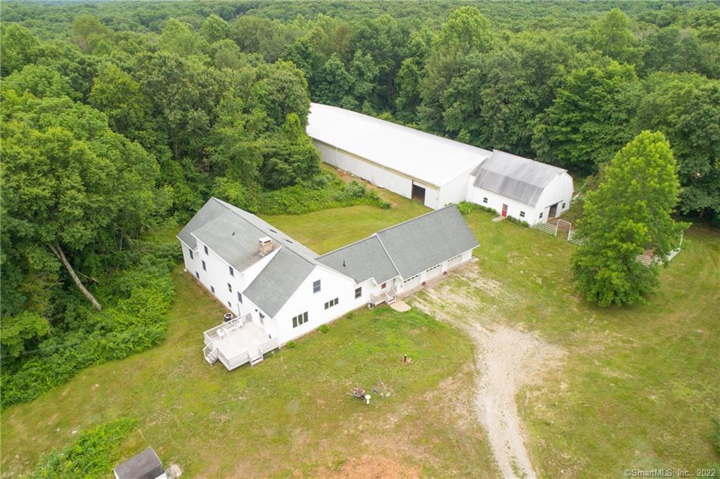 Give me that country life! This property has so many opportunities. Tuck back off Bozrah Rd the property provides complete privacy yet has easy access to RT 2. Want to run your own horse facility, Looking for a place to grow and raise livestock, with 63 acres of property there is a lifetime of options. The current barn has 4 stalls but there is plenty of room to expand. Attached to the barn is a 70 x 180 Indoor riding arena. There is a sand out door ring measuring 20 x 60 meters. The custom build cape home has large inviting rooms, a master bedroom on the main level and 4 additional bedrooms up for an expanding household. 5 paddocks, which have gates between for pasture rotation. Two run-in sheds in one of the paddock.