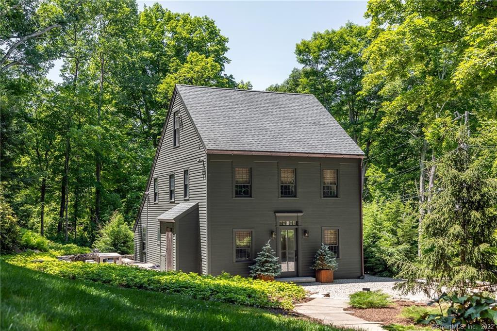 Enjoy the sounds of the Nonnewaug River from this renovated 1870's saltbox. The perfect marriage of old and new, the home offers wide plank floors, horizontal board paneling, barn siding walls, thermopane windows, propane hot air and central air conditioning. The combined living/dining room is comfortable and cozy. Barn wood siding walls add character to the family room with picture windows overlooking pea stone terrace bordered by evergreens. Office, laundry room and full bath complete the main level. The second floor includes two bedrooms, marble and tile bath and the primary bedroom sitting room with exposed beams, closets and built-ins. The third level is dedicated to the spacious primary with vaulted ceiling, full marble and tile bath and walk-in closet. Beautiful stone walls and paths, specimen plantings, multiple sitting spaces and stone fountain are perfect for outdoor enjoyment.