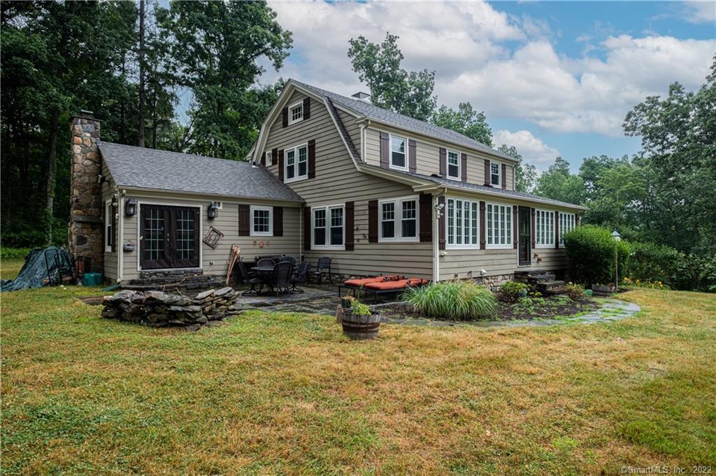 Enjoy country living in Woodbury on 14.5 acres! This 3769 Square foot Colonial features a main house with 4 bedrooms and 3 1/2 baths plus an attached legal 2 bedroom apartment, with a separate entrance. The large front to back formal living room offers a fireplace, wood floors, exposed beams and French doors to a 221 square foot four season sunroom. The large fabulous kitchen offers a fireplace, built-ins, breakfast bar, eat-in area and French doors to a flagstone patio and private yard. The Primary bedroom suite is located conveniently on the first floor, boasting vaulted ceilings and a full bath. The outside of the home features a covered porch, side patio and fire pit, as well as a beautiful rear yard with woodlands, in a private, serene setting! There is also a 2 car garage, barn, shed and kennel. This property is in a great location close to town, which offers access to many great restaurants and antique shops!