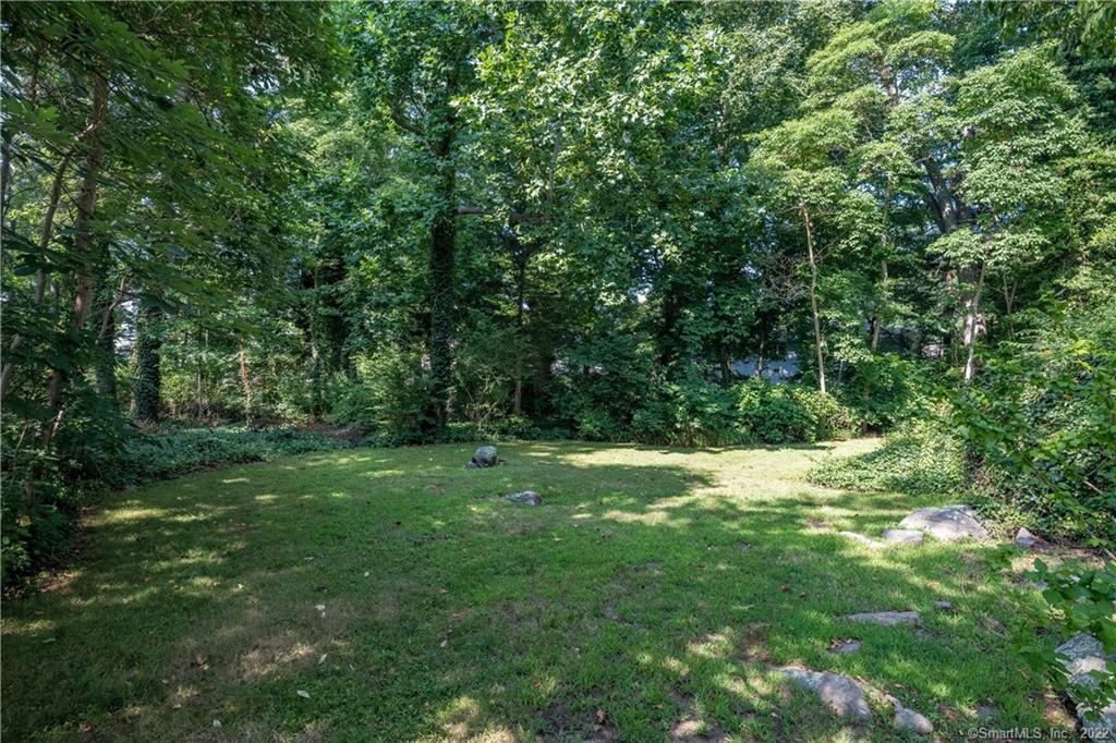 Right in the heart of the Middle Beach Road's water area is a rare opportunity to build on this 1.33 acre lot (R-3 zone). Currently on the property is a seasonal cottage perched on an elevated ledge and hidden in the shade of mature trees. A portion of the lot has been cleared.The access from Middle Beach Road is being extinguished, but the property has a 32' wide strip abutting Park Avenue across which a new access to the property will need to be created. There is also a 30' deeded beach easement to reach Long Island Sound. Plenty of room for chairs and relaxation. Property being sold as is. No drive-bys as property is not currently accessible from Middle Beach Road.