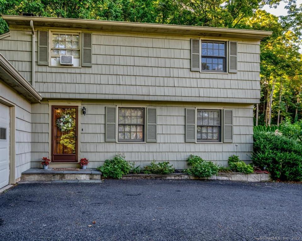 Welcome to this 3 bedroom, 2.5 bath Colonial in Woodbury! This home features a private driveway with an attached two car garage. Upon entering this charming home you will be greeted by exquisite Parisian panels on the walls & they will catch your eye on the doors throughout. On the right hand side, you will find a spacious living room with hard wood flooring, while off to the left there is a cozy den with soothing gray floors, & a raised hearth fireplace. Enjoy beautiful natural lighting from the skylight when unwinding in this room. The Dining room boasts a large triple pane window overlooking the backyard, and is lit at night by a stylish linear pendant chandelier. Cooking in this home's kitchen is a joy with it's ample cabinetry, silver pulls, and granite counters! The center island is ideal as a breakfast bar or additional worktop space. The second floor of this home has 3 spacious bedrooms along with 2 full baths. Spoil yourself with this master bedroom as it has it's own bathroom along with a walk-in closet. Storage is plenty in the 2nd bedroom as a sizeable double closet provides the extra space that you may need. Multiple sliding patio doors provide access to this home's side yard. Once outside you will find a shaded stone patio, a perfect place for relaxing at a firepit. Admire the beauty of nature as you look upon the vast forest in the backyard. This home & property are one of a kind! schedule your appointment today to see it for yourself!