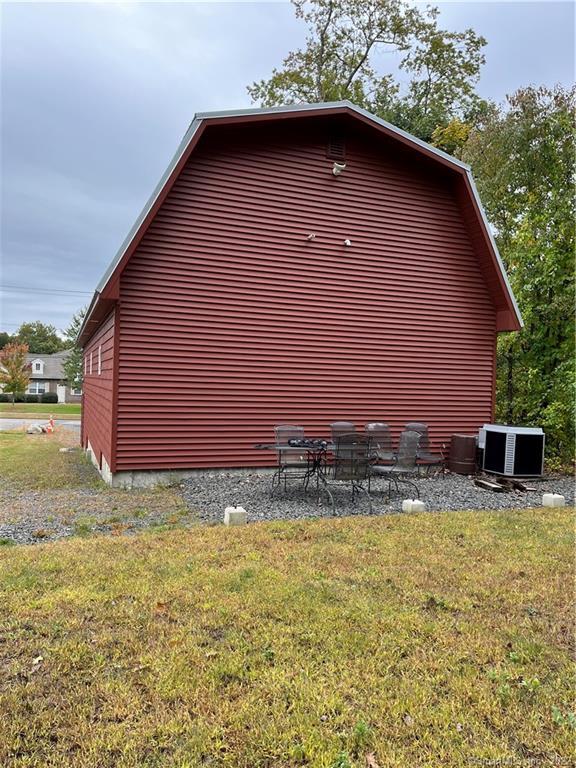 1200 SF accessory building with 14 X 20 motorized garage door. Natural gas 200 AMP service with 100 AMP sub panel. R 49 ceilings, R 21 walls, high efficiency heating unit with A/C. 60 AMP welding outlet, 50 AMPRV plug in, LED lighting, city water, septic system, gravel driveway, vinyl siding, and a metal door.The building is in a residential zoneThe building is able to be changed to a residential property.