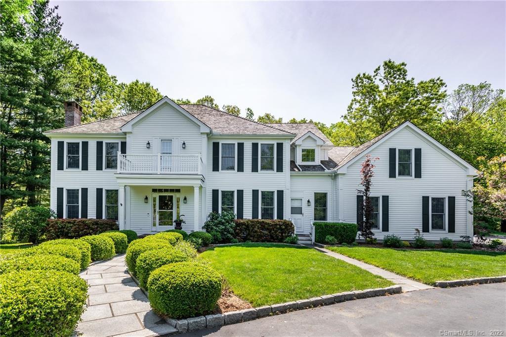 Tucked away at the end of a lightly wooded cul de sac is a curving tree-lined drive that leads to this classic central gabled colonial. The professionally manicured lawn provides the perfect green backdrop to this freshly painted white home. Bordered by Hesseky Brook and the conserved land surrounding it, you are able to enjoy the seasonal sights and sounds of peepers, ducks, and swans. The exterior provides ease in outdoor living; trex decking, clean pathways, and ample lighting all play a part in creating a space that welcomes one to spend time outdoors. Multiple entries allow for a flow from the outside in and once indoors the theme of clean and organized space continues. The side entry is fitted with custom cabinetry for neatly storing all of the everyday items we carry to and from our home. Inset craftsman cabinets and stainless appliances make the kitchen an area that is bright and welcoming. High ceilings and large windows create a space that is flooded with natural light further amplifying the feeling of cheerfulness this home provides. Refinement is found in design elements such as the coffered dining ceiling, crown moldings, and double-height foyer with a central staircase. There is a relaxed sense of movement through the home as one room opens to the next and staircases connect the two floors from each end. Find yourself immersed in the joy that comes from living in a thoughtfully designed home within a community of thinkers, creators, and designers.