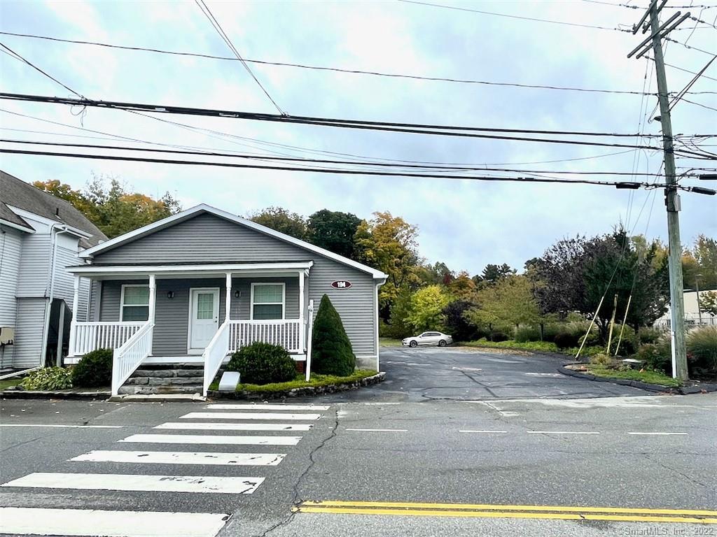 Renovated office building with 2 office suites. The building is equipped with a wheelchair ramp, kitchen with granite counters (11x13ft), full bathroom with shower (7x12ft), half bathroom, 12 paved parking spaces, and a gravel parking area for 8 or more vehicles. The main office space has 9-foot high ceilings. The back office space, kitchen, and bathrooms have 8-foot ceilings. Office Suite 1 Approx. 1350 sf., Office Suite 2 Approx. 450 sf. 18x25ft. Additional space in central kitchen and bathrooms of approximately 378 for a total building finished space of 2178 sf. Tenants pay for air conditioning, cable TV, phone, internet, capital improvements related to their build outs, credit check during application, heat (bottled gas), hot water(electric) janitorial services, liability insurance, maintenance and repairs, parking, security system and snow removal and shoveling. Owner includes water, electricity, landscaping, lawn care, weeding flower beds, and exterior maintenance. One or more of this property's owners is a Real Estate Licensee.