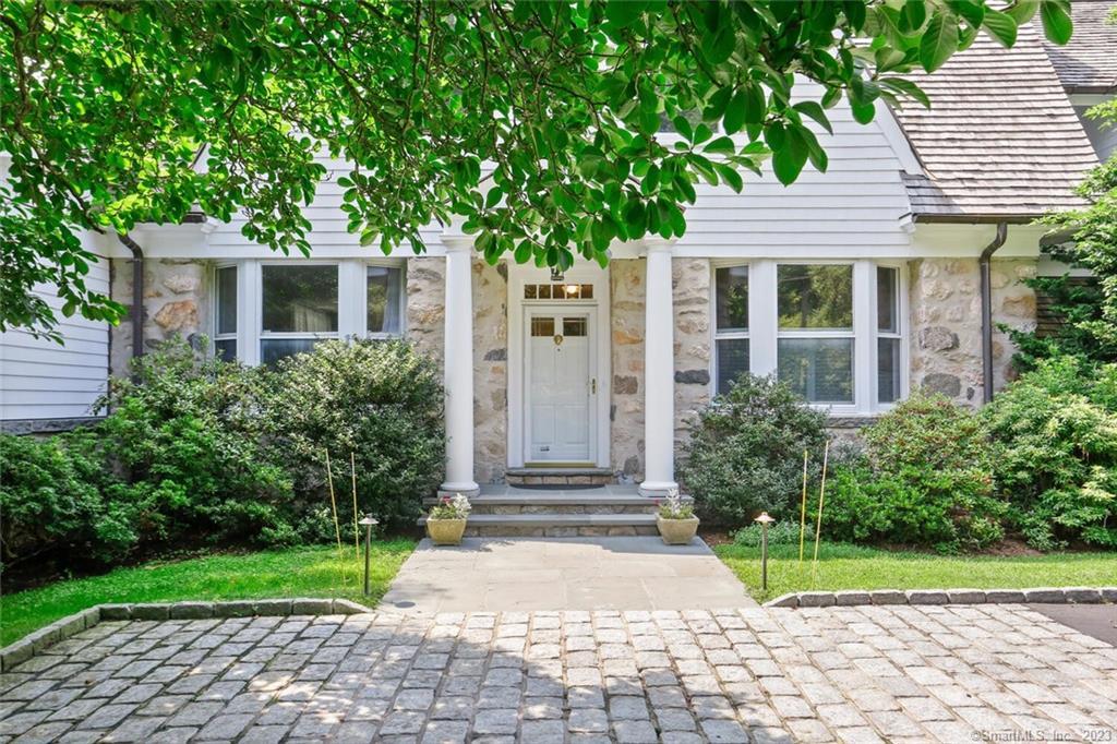 Elegant and expansive five-bedroom Colonial graces 2.42 private acres with pool, wraparound deck and stone terrace overlooking a brook near schools, town and trains. Thoughtfully renovated, well-maintained 1900 home boasts a gracious, freshly painted interior on four levels. Main level showcases an inviting center hall entry, stylish living room with fireplace, French doors to sun porch; dining room, library/office; chef's kitchen open to family room with fireplace, mudroom, powder room and attached two-car garage. Primary bedroom suite with sitting room, office, balcony, spa bath, walk-in closets; three bedrooms and hall bath comprise second floor. Top floor offers media room; bedroom and full bath. Features walkout lower level play/game rooms with bar, full bath and laundry room.