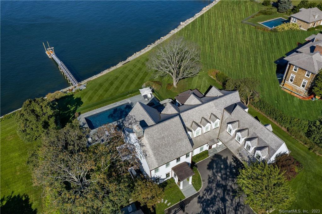 A rare opportunity to own a state of the art, Long Island Sound, waterfront home on one of the most coveted streets in Darien. Completely renovated and expanded in 2019, this spectacular home was fashioned with an innovative, contemporary, Hamptons style flair while maintaining the understated classic appeal of the original Nantucket style home. Equipped with the latest technology, the home features a Crestron Smart System including automated shades, Lutron lighting, Sonos and security system. Designed for seamless indoor and outdoor living, the property includes a deep-water dock, pool, spa and outdoor kitchen, with rolling lawn down to the water's edge. The sweeping panoramic views of the Long Island Sound, Noroton Harbor, the Manhattan skyline, and the incredible sunsets are breathtaking. Have it all and enjoy year-round vacation living and all that the quintessential New England town of Darien has to offer. Just an hour from the cityunlike anything else on the market.