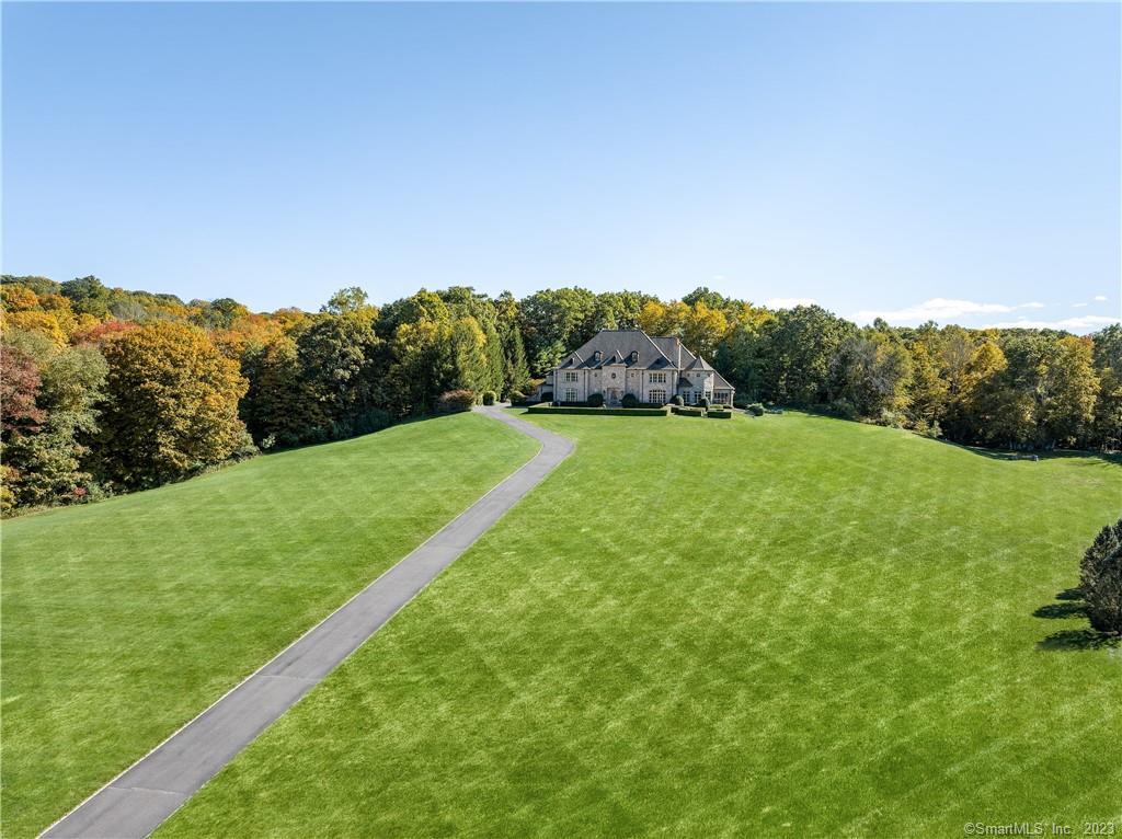 Red Gate Farm- A rare opportunity to acquire a TURN KEY equestrian property in Fairfield County with a main house set high overlooking the 54+ bucolic acres and the Aspetuck River. The equestrian facility includes 3 barns w/ 69 stalls, wash stalls, tack rooms, laundry, rubber flooring, full haylofts, grand prix/derby field, indoor & outdoor rings, round pen, apts. for staff, office/viewing room, gym, paddocks, fenced pastures & equipment garages. Accessed by a long driveway set high on a hill is a luxuriously appointed stone manor home w/ an18' grand entry,  formal lvng rm, dining rm, kitchen/family room, bar, 4 bedrooms, 5.1 bathrooms, 6 fireplaces, walk-in wine cellar & elevator to all 3 floors. Absolutely beautiful and an exceptional opportunity.