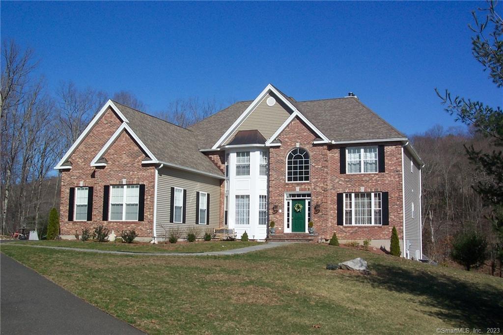 Tucked away at the end of a cul-de-sac, this stunning custom built Colonial with superior craftsmanship borders the protected land of the Hesseky Brook Preserve surrounded by the sights and sounds of nature. The interior spaces include high-end trim along with coffered and vaulted ceilings, hardwood floors, and detailed crown moldings, which all create an elegant interior. High ceilings and large windows flood the home with natural light. Enjoy the easy-flow floor plan with wide doorways and thoughtfully laid out rooms. The Kitchen breakfast nook opens to the spacious, vaulted ceiling family room with a cozy gas fireplace surrounded by built-ins. Also on the main level is a formal dining room with a Butler's Pantry, a Living Room and an home office or guest bedroom with a full bath. The primary bedroom suite has vaulted ceilings, a luxury bath, shower and 2 oversized walk-in closets. In addition, the 3 upper level bedrooms each have access to a full bath. There is a walk-up attic with room for storage and an elevator which can take you to all 3 levels of the home. The lower level provides additional space for recreation, a workshop, indoor hot tub and doors that lead out to the salt water, in-ground gunite pool. Other features are a new roof, deck, an attached over sized 3 car garage that leads to a tiled mud Room with built-ins and laundry area. A private and magical location, just a few minutes from Historic Woodbury Center and 90 minutes from NYC.