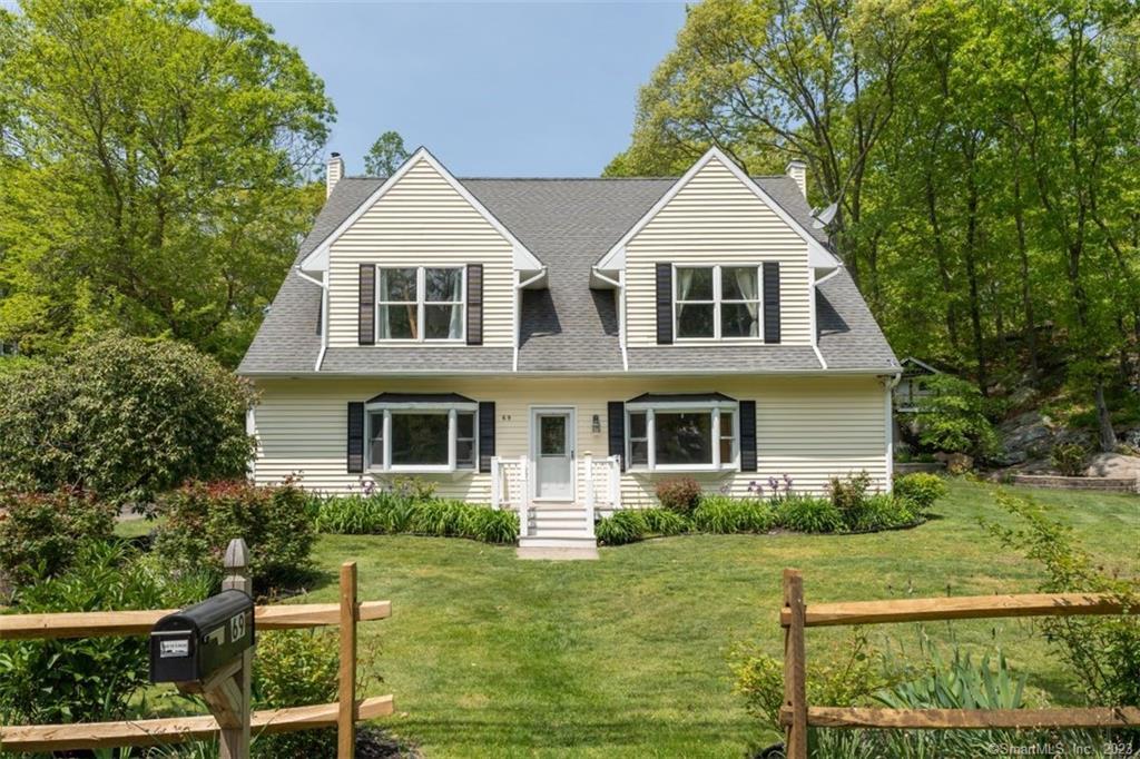 This special home, just one mile from the historic Guilford Green, was substantially renovated in 2005 and further updated within the past five years, including the addition of 800 square feet on the fully finished third floor, accessed by a spiral staircase and bringing the total square footage to more than 3900. Flooded with light and with high ceilings and hardwood, the main level features an open floorplan living room/family room with wood burning stove and built in cabinets, a private office and a full bath with stall shower. The updated kitchen with over-sized island, granite counters and newer appliances is adjacent to a large dining room. The second floor has hardwood floors throughout and three bedrooms including the spacious primary suite with tile shower, claw foot tub and walk-in closet. Outdoors the expansive deck is perfect for entertaining and a kid-size club house completes the picture. The property backs up to Westwoods Trails and is close to beaches and transportation. Recent upgrades include an Electric Vehicle charger and generator and RV hook-ups as well as new washer, dryer, refrigerator, dishwasher, hot water heater, wood stove and more.