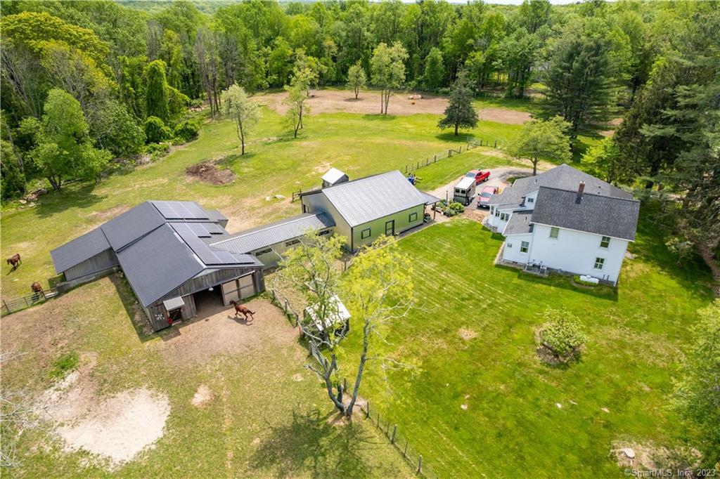 Welcome to this charming and pristine 1900's colonial farmhouse and equine property, offering a perfect blend of timeless allure and modern amenities that today's discerning buyers seek. Nestled on a 10+ acre corner lot, with frontage on two tranquil country roads. Large barn with oversized garage door and 5 frost-free water hydrants, lead to stable with 5 horse stalls, feeding room, tack room, and birthing stall. (Room for additional horse stalls) 3 electric fenced-in paddocks, two run-in sheds, and two cleared pasture areas. South paddock perfect for 2 future rings. Meticulous craftsmanship throughout this fine home. Adorned with custom shutters, porcelain and red slate floors, yellow pine wood flooring, and European radiators. The remodeled chef's kitchen with both wood and granite counters and breakfast nook is equipped with top-of-the-line stainless steel appliances with a large island that doubles as a breakfast bar, complemented by two dishwashers. Each floor features a primary bedroom with en suite. Expansive windows bathe the family room in natural light, while an inviting veranda off the upstairs bedroom offers a picturesque retreat. Additionally, the main level bedroom is thoughtfully designed and handicap equipped. Notable features include a high-capacity propane Briggs & Stratton generator, exposed wood beam in kitchen, barn doors, and an open floor plan. Solar panels are owned and paid for. This magnificent equine property is truly one not to be missed!