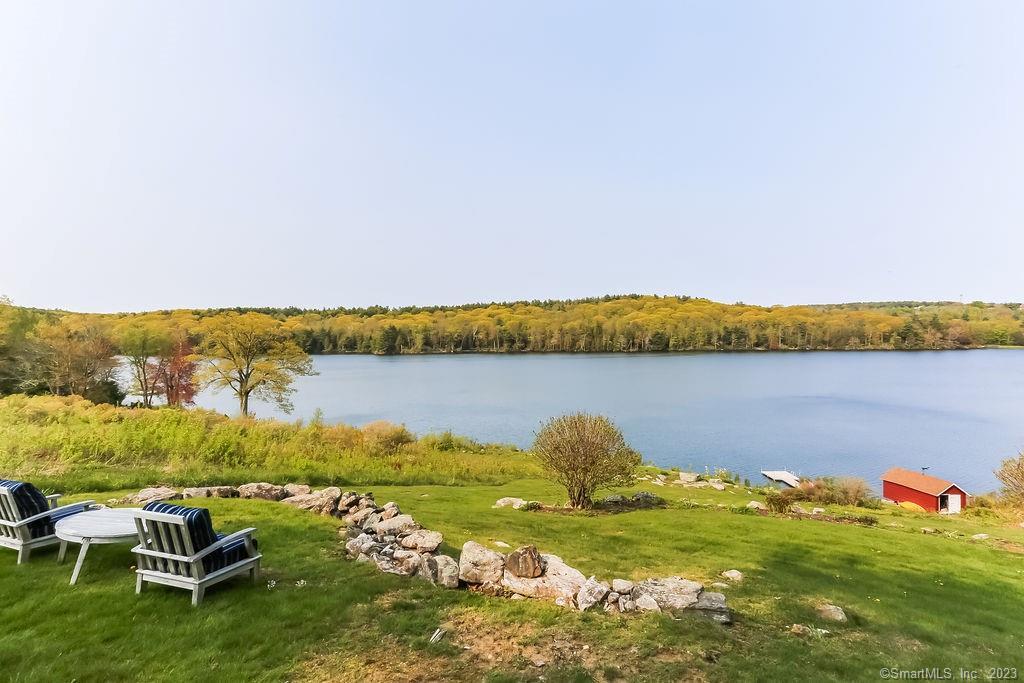 THERE IS NO PRICE FOR PARADISE! Live year round in this Dutch Colonial Cottage, situated next to a stunning 25-acre land trust and tucked on 2+ acres of private lakefront property. This home offers dreamy views of Park Pond and the undulating Berkshire Foothills in tranquil Winchester Center, approximately two hours from NYC and Boston it's a perfect 2nd home location.Well positioned on a mild hill and surrounded by stone walls in the New England style, the home captures attention with its picturesque splendor.Inside, the great room with wood beams serves as the centre of the house. Enjoy expansive views of the water on one side and a sprawling field stone fireplace on the otherside. Hardwood floors and accessible laundry facilities can be found in the eat-in kitchen, and a heated sunroom adjacent to the great room invites you to unwind or socialize with loved ones while admiring the mesmerizing waterfront view.A bedroom and a full bathroom are located on the main level, with two additional bedrooms & a second full bathroom situated on the upper level. The primary bedroom has central air for those hot summer nights that also cools the rest of the house. On the gorgeous 82-acre Park Pond, a well-kept boat house by the lake offers plenty of space for all your water toys.Boats are allowed w/ no more than 25hp motor. DON'T WAIT TO MAKE THIS PIECE OF PARADISE YOURS FOREVER AND IMMERCE YOURSELF IN LAKEFRONT LIVING TODAY!