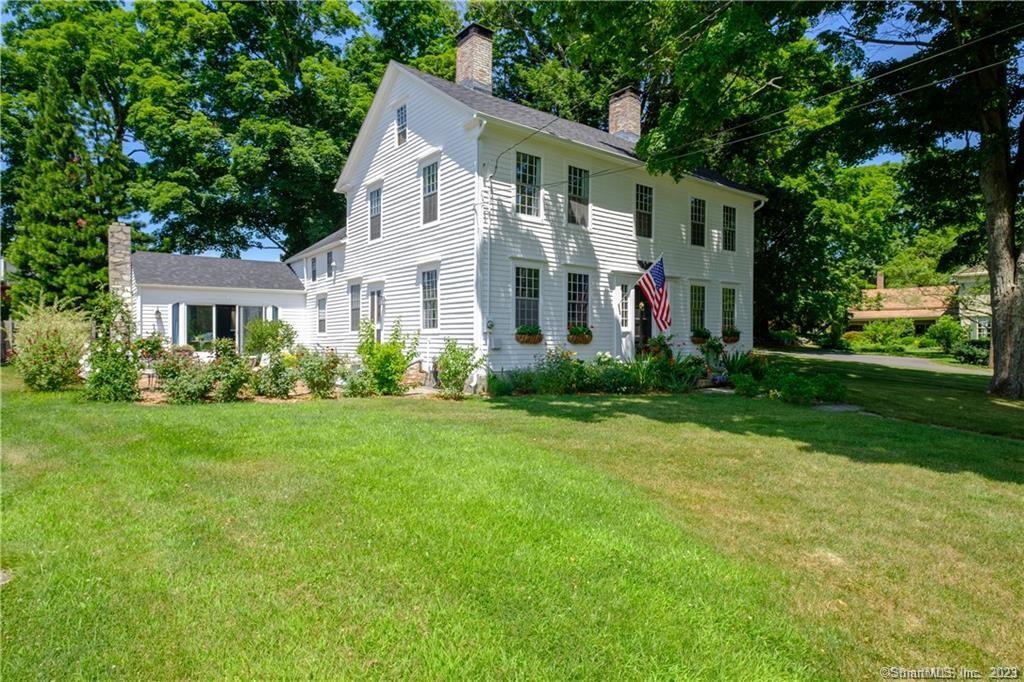 Originally the Earl Munson home. This 18th Century antique home is situated in Woodbury's picturesque Historic District on the west side of Main Street and is exquisitely restored with recently painted white clapboard siding, new gutters, 12 over 12 windows, two chimneys and a new 50 year roof. This home offers many possibilities as it was a three family home and converted back to a one family and features 5 bedrooms, 5 fireplaces (3 functioning) and 3 full baths. Second kitchenette on second floor offers perfect opportunity for in law set up or Au pair quarters. Tastefully updated with fresh paint, remodeled kitchen featuring new appliances, spacious main living room with built ins and wood stove. This home features stunning wide board oak wood floors throughout, is connected to city water, has a newer septic- installed 2012 and a two car detached garage. This property is surrounded with beautiful plantings and brick patio. This vintage residence is walking distance to local businesses, fine dining and only 90 minutes to NYC. The Sunday New York Times Living In section said Woodbury was Peace, Quaint Beauty and a Sense of History (5/16/21) and Readers Digest called it the Best Small Town in Connecticut.