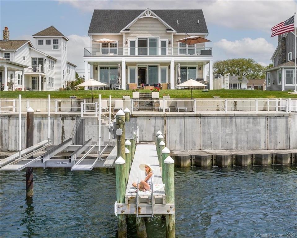 This exquisite Boaters home is nearly new with a very special, hard-to-find, amenity that any seafarer would covet: a hydraulic boat lift that can currently accommodate up to a 16000lb / 37' boat! If yours is larger, capacity can be increased/upgraded. When you pull up to your own dock, with a few clicks of a remote control, your boat is gingerly raised from the sea! Your dock is lodged to a sleek new $400K multi-level sea wall with LI views that stretch to the horizon. It's a short walk to the gorgeous Clinton Beach.No expense was spared building this home 5 years ago, it is meticulously crafted with soft sand-colored 5 white oak floors, a coffered ceiling, plate glass railings (inside and out), luxe lighting fixtures, a sumptuous Primary suite with divine bath, grand WI closet with sea views and its own 1200 sq ft deck. The chef's kitchen boasts custom Italian Cabinetry, Cambria Quartz waterfall countertops, Sub Zero/Wolfe appliances and a huge center island that can seat 6! The ceilings are 9' throughout and there's a professionally equipped oceanfront bar, that steps out to the ground level 1200 sqft bluestone patio for carefree indoor/outdoor entertaining. 1st flr BR suite for guests, or alternate Primary.This NEST smart home has; a full basement, a full attic, hurricane-impact windows/doors, indoor/outdoor sound system, full irrigation, hot water-on-demand, blue light air purification and is heated with propane. < 2 hours from NYC!