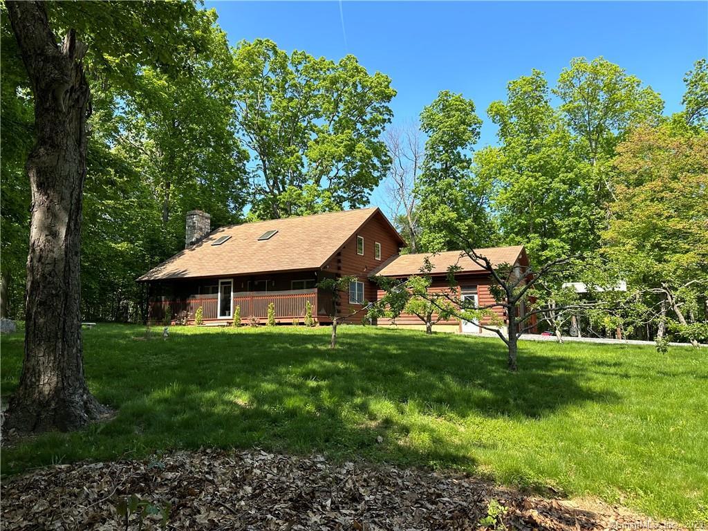 Situated in the northwest corner of Litchfield County in Goshen on 5.7 private acres is this updated Log/Cape Cod home featuring an updated kitchen with granite countertops, stainless steel appliances and hickory cabinets; dining room with hardwood flooring; great room with Fieldstone wood burning fireplace, skylight and ceiling fan and full bath. The upper level is comprised of a loft bedroom with a deck, hot tub and firepit; two guest bedrooms with wall to wall carpeting and a full bath. Attached two car garage; newer furnace, central air and hot water heater installed 2021 and mobile generator hook up. A nature lover's paradise! Appreciate the peace and tranquility along with the wildlife Enjoy all that Litchfield County and Goshen has to offer including country living; local farms, chocolate, wineries, hiking, biking, fishing, golfing and horse back riding.