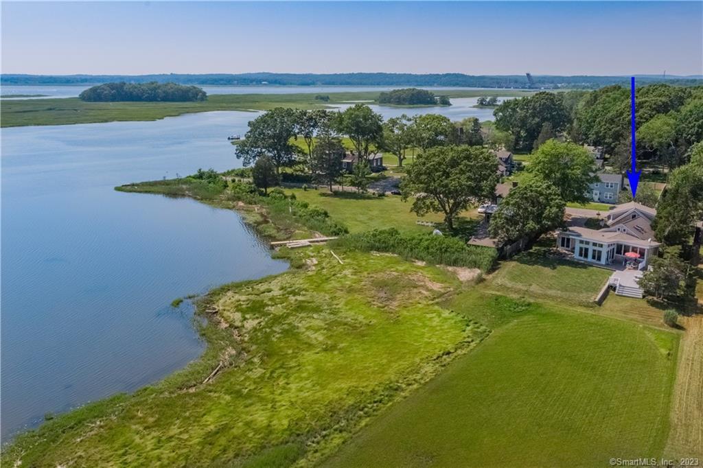 Incredible waterfront home in Old Lyme! From the moment you pull into the stone paver driveway, it is apparent that attention has been paid to every detail. The beautifully landscaped property extends into the marsh. Watch the wildlife along the New England shoreline from inside the home or from your outdoor living areas. A large deck has ample space for sunbathing, grilling, or entertaining guests. There is an option to put in a dock for all your water activities. Inside, an open floor plan is full of charm and luxury amenities. A wood-paneled ceiling and Brazilian cherry hardwood floors run throughout the main living areas. Never ending views can be seen from the wall of windows on the first level. Enjoy the benefits of a first-floor master suite and first-floor guest bedroom. In addition to a flex loft space, you can enjoy a finished room above the detached garage providing additional space for all of your needs. Underground utilities mean your views are unobstructed all year long. The office/studio is nicely finished and has a separate entrance. Sit on the expansive deck and enjoy viewing the abundant wildlife, views of the Connecticut River, Fenwick and Long Island Sound in the distance. Close to Tennis, Golf, Marinas, Farmer's Markets, Yoga, Art Galleries, Restaurants and Museums. Only two hours to New York and Boston.