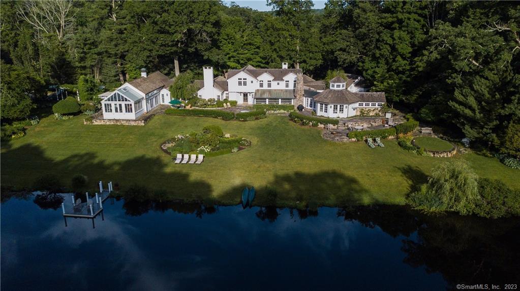 This is a once-in-a-lifetime opportunity to own Long Pond Farm, one of Fairfield County's most prized Country Estates, & a perfect retreat for relaxing & entertaining. This elegant 5 BR, 7 BA classic CT home is nestled on nearly 8 private acres of lush landscaping that include gorgeous mature specimen trees, flower & vegetable gardens, stocked half-acre pond, tee box, koi pond, meandering paths, stone patios w/pergolas, barn garages, & charming stone studio. Inside the light-filled spacious Main House, you will find historically accurate detailing such as random width wide-plank flooring, coupled w/luxurious amenities & water views. Oversized chef’s KIT showcases an imported Lacanche range, tiger maple Subzero, marble island, custom China breakfronts w/zinc counters, Breakfast RM & walk-in pantry. Just beyond is a sophisticated Dining Rm w/FP, stone floor & wall of windows. Octagonal Living Rm is graced with a dramatic FP + windowed cupola. 2 story Family Rm has floor to ceiling stone FP & architectural beams. 1st floor Primary Bdrm offers 2 separate Bathrooms, a 21-foot-long custom Dressing Rm and access to the home’s Wellness Wing which houses a luxurious 40 foot long Indoor Swimming Pool, Spa, and Home Gym. Two Offices & Library offer generous, quiet & sun-filled work-from-home spaces. Upstairs there are four more sunny, spacious Bedrooms, and 2 Jack-and-Jill Baths. Less than 60 miles to NYC in desirable West Redding. Check out the walk thru tour at https://bit.ly/3P4EcTW