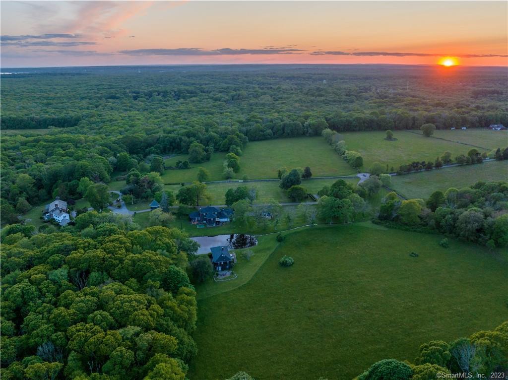 Experience timeless elegance at the Sergio Franchi Estate in Stonington. Enter the 200-acre compound of world-renowned tenor, Sergio Franchi, and immediately feel its warmth, charm, and elegance. As you walk through the property, graced with mature trees, 4 guest cottages, a silo, and a studio, you can almost hear the sounds of music rising over the rolling fields and open pastures surrounded by hand-stacked stone walls. The beautifully maintained custom-built home is one of 5 on the property. The main house is a 6, 300 square-foot, slate-roofed Colonial with seven bedrooms and stunning spaces including a formal dining room with stained glass windows and hand painted wallpaper by Zuber. The expansive country kitchen has a walk-in China closet perfect for all those pieces ready for special occasions. The main parlor and bar is a cozy space perfect for sitting by the fire or entertaining. A large sunroom with an interior pool leads out to an expansive patio perfect for al fresco entertaining. Each of the 7 bedrooms has a private bath. The property has been the site of weddings and music events and has a private chapel. This Home has so many possibilities! Family Compound, Subdivision, Event Venue, Vineyard and Retreat Home. Come experience the elegance and charm of this lovely Stonington property. Conveniently located between NYC and Boston.