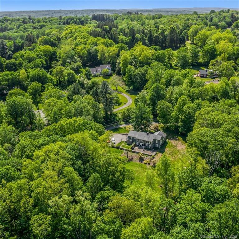 This exceptional raised ranch on one and a half acres of land offers an idyllic country retreat with panoramic views from every room. One of the standout features of this property is its extensive sun-drenched views of the surrounding countryside. Large windows throughout the home frame the picturesque landscape, providing a constant connection to nature. Whether you're enjoying a peaceful morning in the bedrooms or entertaining guests in the living room, the breathtaking views will always be a highlight.The home features five bedrooms and three full bathrooms, offering ample space for comfortable living. The primary en suite boasts a separate door on one end of the home for added privacy, allowing you to retreat to your personal oasis. The heart of this home is the open concept kitchen, equipped with complete with double ovens, island, wine fridge, farmhouse sink and it's own fireplace. The living room and family room also feature their own fireplaces, creating a warm and inviting atmosphere throughout the home. With central air conditioning, you can enjoy year-round comfort and climate control . Seamless indoor/outdoor living with stone covered patio overlooking the property, perfect for entertaining. Location-wise, Redding enjoys a prime position in Fairfield County, offering a serene and picturesque setting while providing convenient access to nearby cities. It is approximately 15 miles away from Danbury, Connecticut and 30 miles from the city of Stamford, Connecticut.