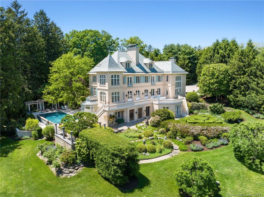 ASTOUNDING WATER VIEWS! South Wilton meets Europe in this stunning waterfront estate on 2.29 lush acres. Located on coveted Nod Hill Road the residence boasts unparalleled luxury and craftsmanship. Featuring soaring ceilings & windows, custom millwork, top of the line building materials & ironwork, limestone fireplaces from France, doors from Italy, hand painted murals and slate roof. This home cannot be replicated at this price. With four finished floors, 9,000 SF, 5 bedrooms, 7 baths, family and guests will never want to leave. The light filled interior showcases a seamless blend of warm modern comfort and timeless elegance. The spacious kitchen is equipped with an expansive island, pantry, breakfast room and French doors which open to the expansive veranda. The two-story family room with elegant iron railings, built-in bar & bookshelves, 16th century fireplace imported from France, and cozy window seating offers a tranquil escape. The owner's suite is a private oasis complete with its own sitting room, French limestone fireplace, dressing room and luxurious ensuite bath. Each additional bedroom offers its own unique charm, ensuring comfort and privacy for everyone in the household. Step outside onto one of the many terraces to enjoy the zero-edge infinity pool and shaded pergola, panoramic water views and manicured gardens. Experience the epitome of luxury living and create lasting memories in this exceptional residence.