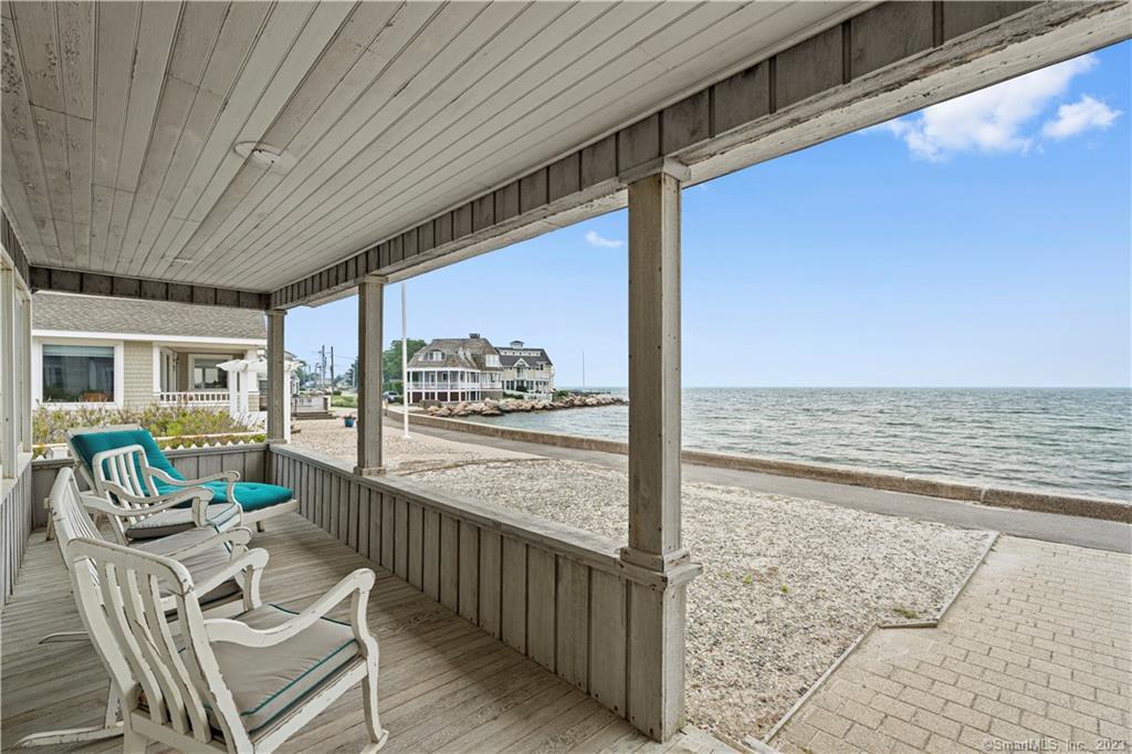 Listen to the ocean waves and watch the boats go by from your covered porch at number 10 Boardwalk, a superbly sighted oceanfront home in beautiful Groton Long Point! This spacious 6-bedroom and 3-bathroom home on a rarely available large front-to-back lot is being offered for sale for the first time in 45 years.With unobstructed water views, spectacular sunsets, and direct access to Groton Long Point's Main Beach, this year-round home provides the perfect setting for easy beachfront living. The open living/dining room and kitchen, with built-in storage and a wood-burning fireplace, make entertaining a breeze. And the many bedrooms and bathrooms ensure you can always host a crowd.  A separate detached 2-car garage is great for bike and boat storage, and two outdoor showers to help keep the sand outside.The property is directly on Main Beach and in the center of Groton Long Point, providing quick access to the tennis, pickleball, and bocce courts, as well as the playground, fitness loop, Point Spa, and everything else GLP has to offer!  GLP is conveniently located between Boston and New York and minutes to historic downtown Mystic, Stonington Borough, and Rhode Island beaches. Take advantage of this unique opportunity to own a prized piece of Groton Long Point and schedule your appointment to see this property today.